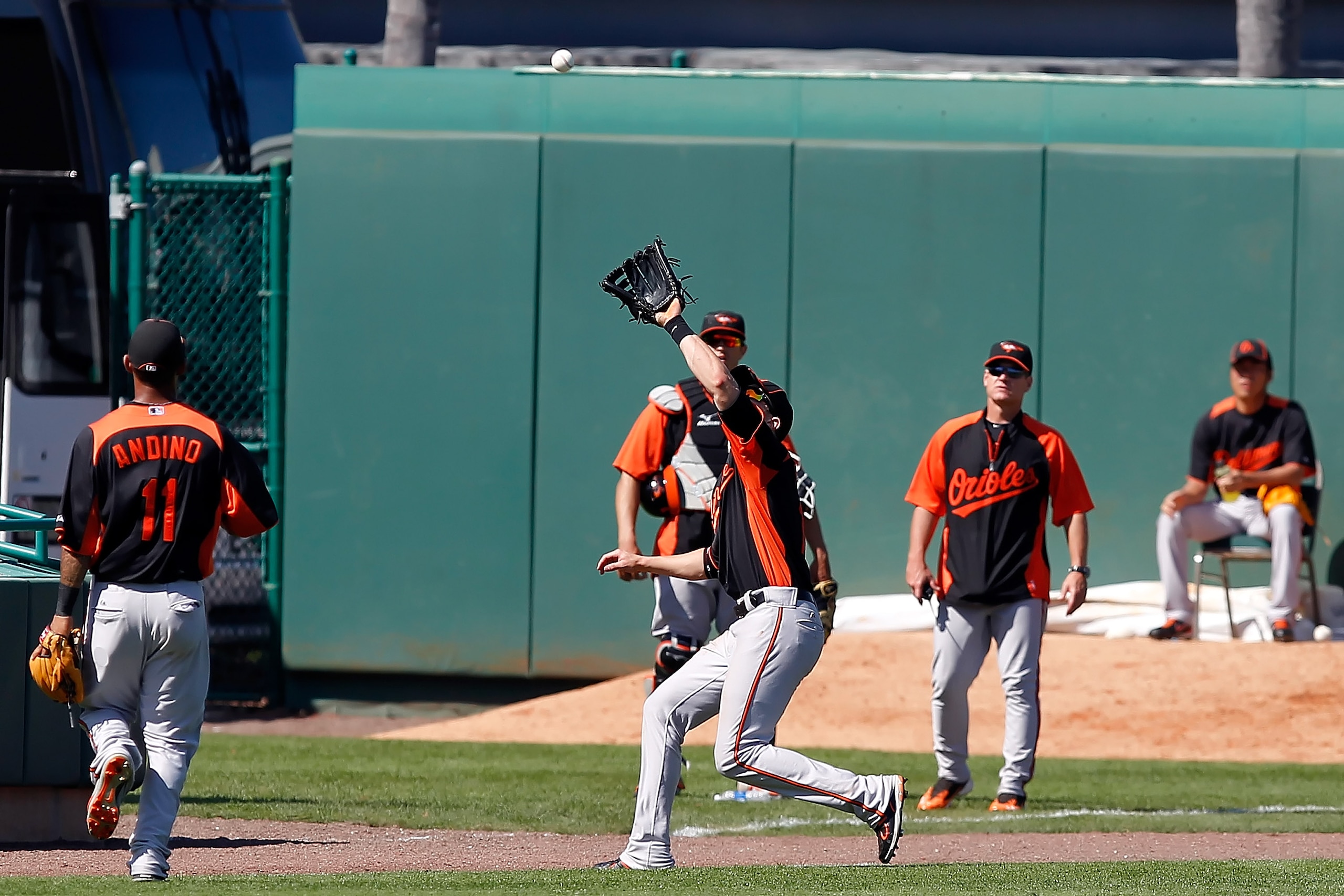 BRADENTON, FL - FEBRUARY 28:  Outfielder Nolan Reimold #14 of the Baltimore Orioles catches a fly ball against the Pittsburgh Pirates during a Grapefruit League Spring Training Game at McKechnie Field on February 28, 2011 in Bradenton, Florida.  (Photo by