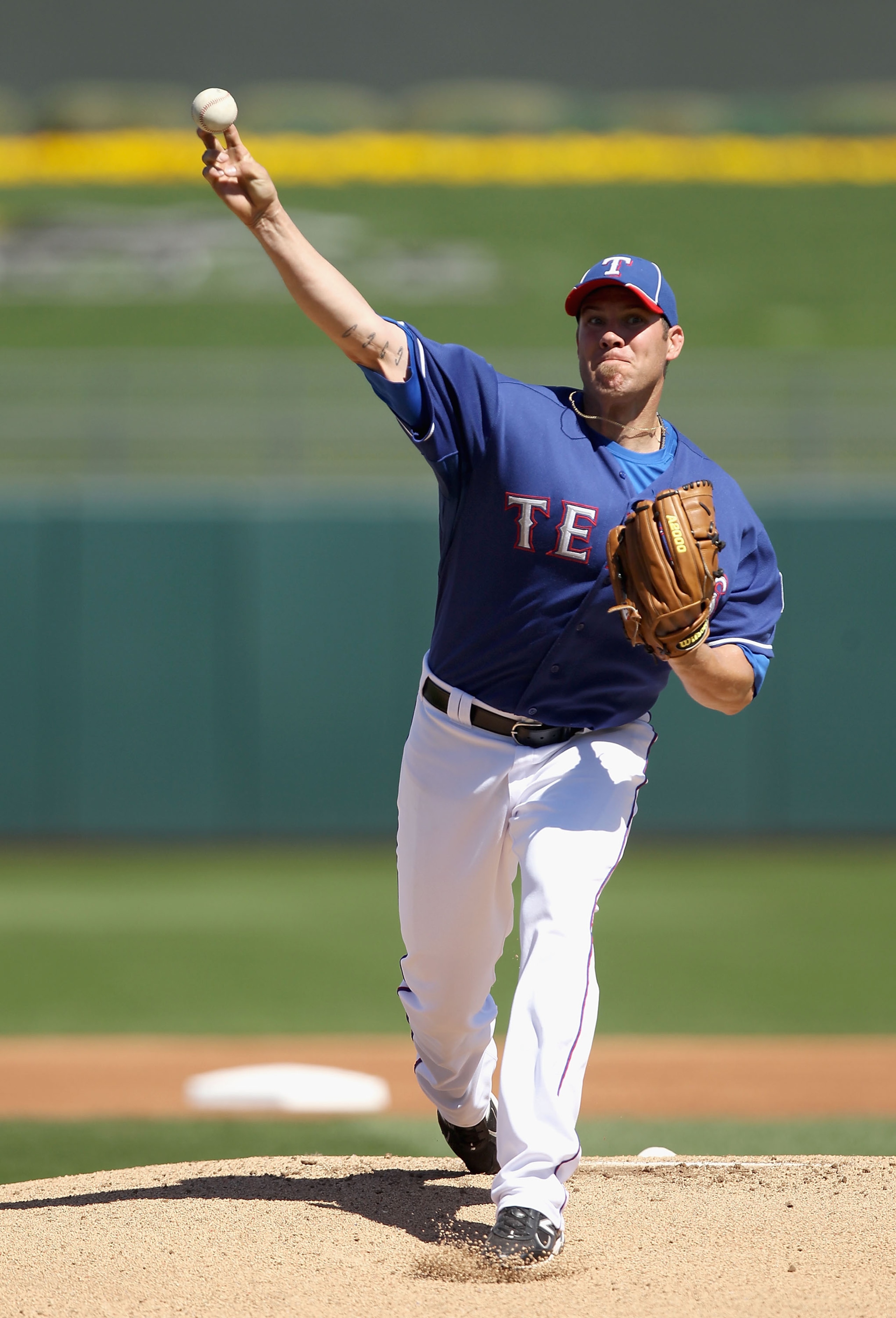 SURPRISE, AZ - MARCH 11:  Starting pitcher Colby Lewis #48 of the Texas Rangers pitches against the Cincinnati Reds during the spring training game at Surprise Stadium on March 11, 2011 in Surprise, Arizona.  (Photo by Christian Petersen/Getty Images)