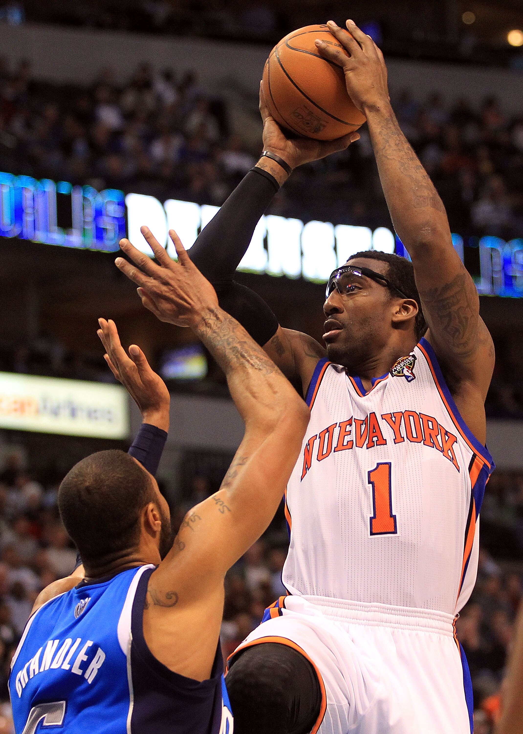 DALLAS, TX - MARCH 10:  Amar'e Stoudemire #1 of the New York Knicks takes a shot against Tyson Chandler #6 of the Dallas Mavericks at American Airlines Center on March 10, 2011 in Dallas, Texas.  NOTE TO USER: User expressly acknowledges and agrees that,