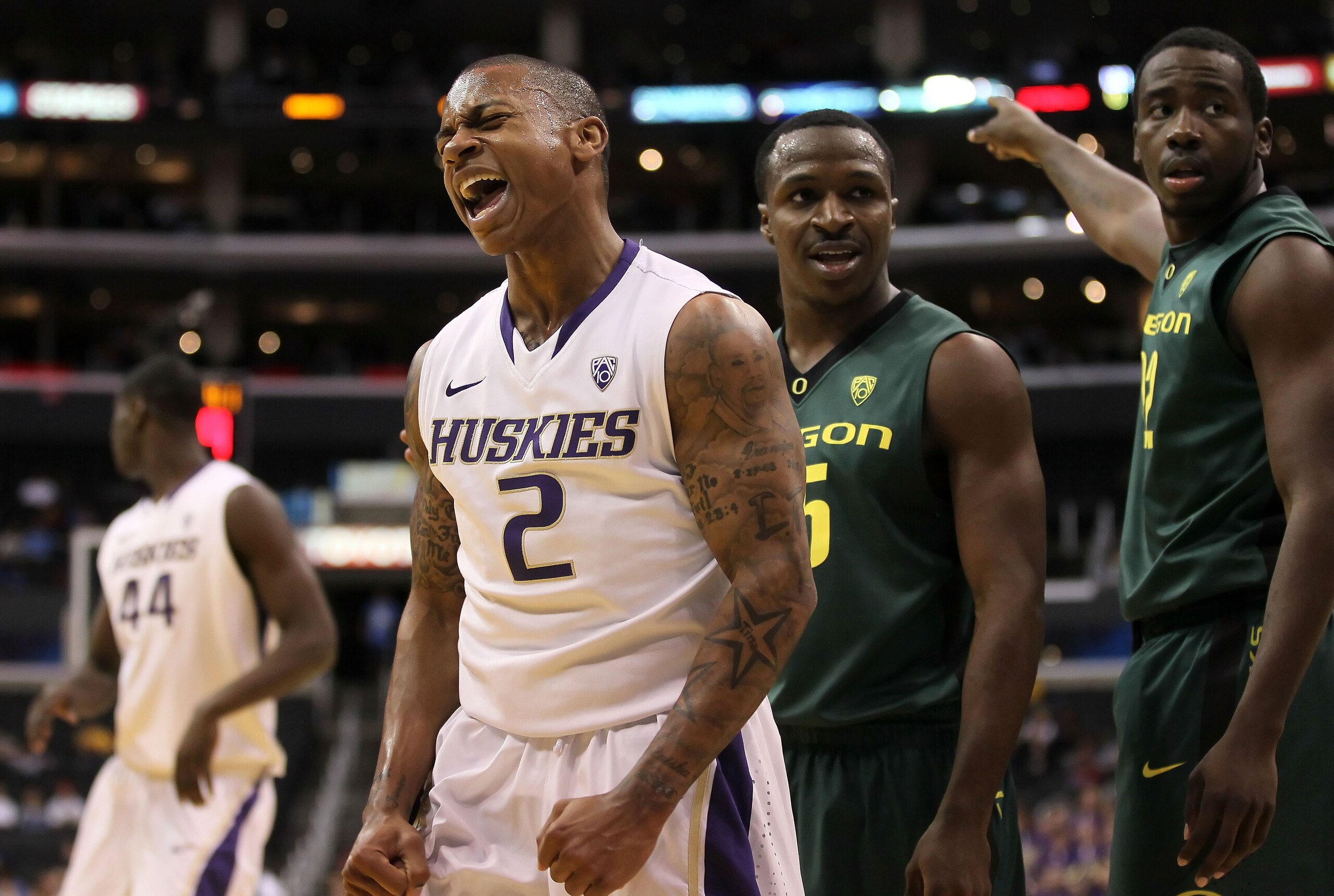 LOS ANGELES, CA - MARCH 11:  Isaiah Thomas #2 of the Washington Huskies reacts in the first half as he stands alongside Jay-R Strowbridge #55 and Teondre Williams #22 of the Oregon Ducks in the semifinals of the 2011 Pacific Life Pac-10 Men's Basketball T