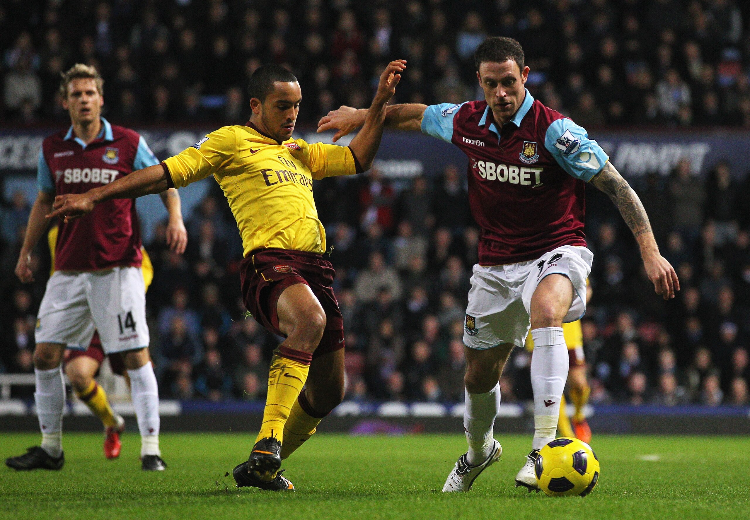 LONDON, ENGLAND - JANUARY 15:  Wayne Bridge of West Ham United is closed down by Theo Walcott of Arsenal during the Barclays Premier League match between West Ham United and Arsenal at the Boleyn Ground on January 15, 2011 in London, England.  (Photo by C