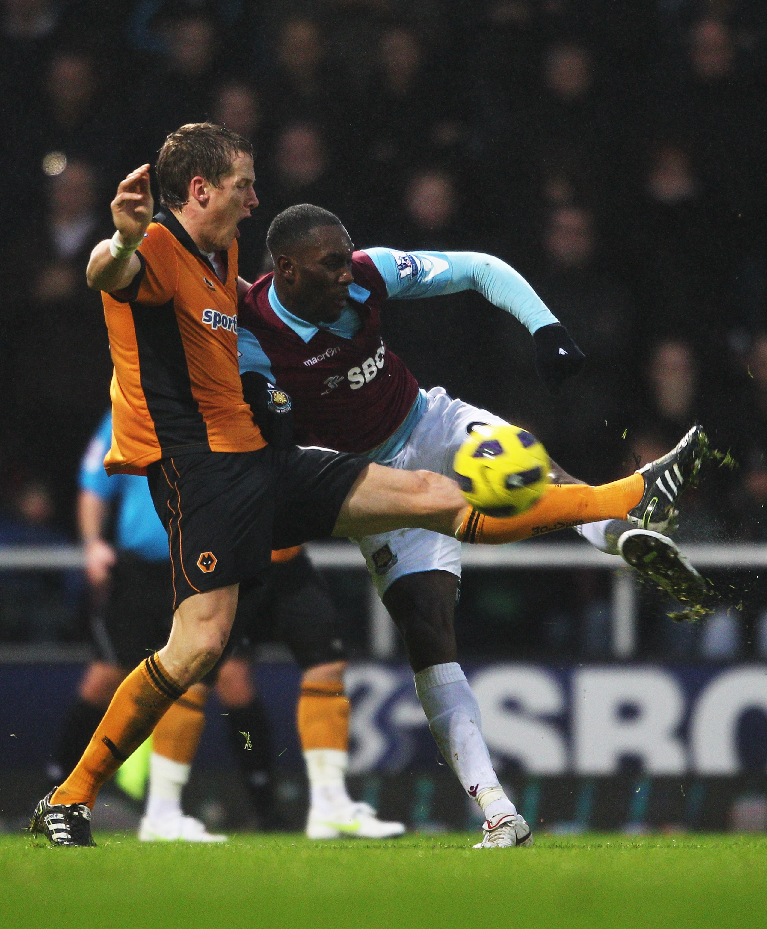 LONDON, ENGLAND - JANUARY 01:  Carlton Cole of West Ham United is challenged by Christophe Berra of Wolverhampton Wanderers during the Barclays Premier League match between West Ham United and Wolverhampton Wanderers at the Boleyn Ground on January 1, 201