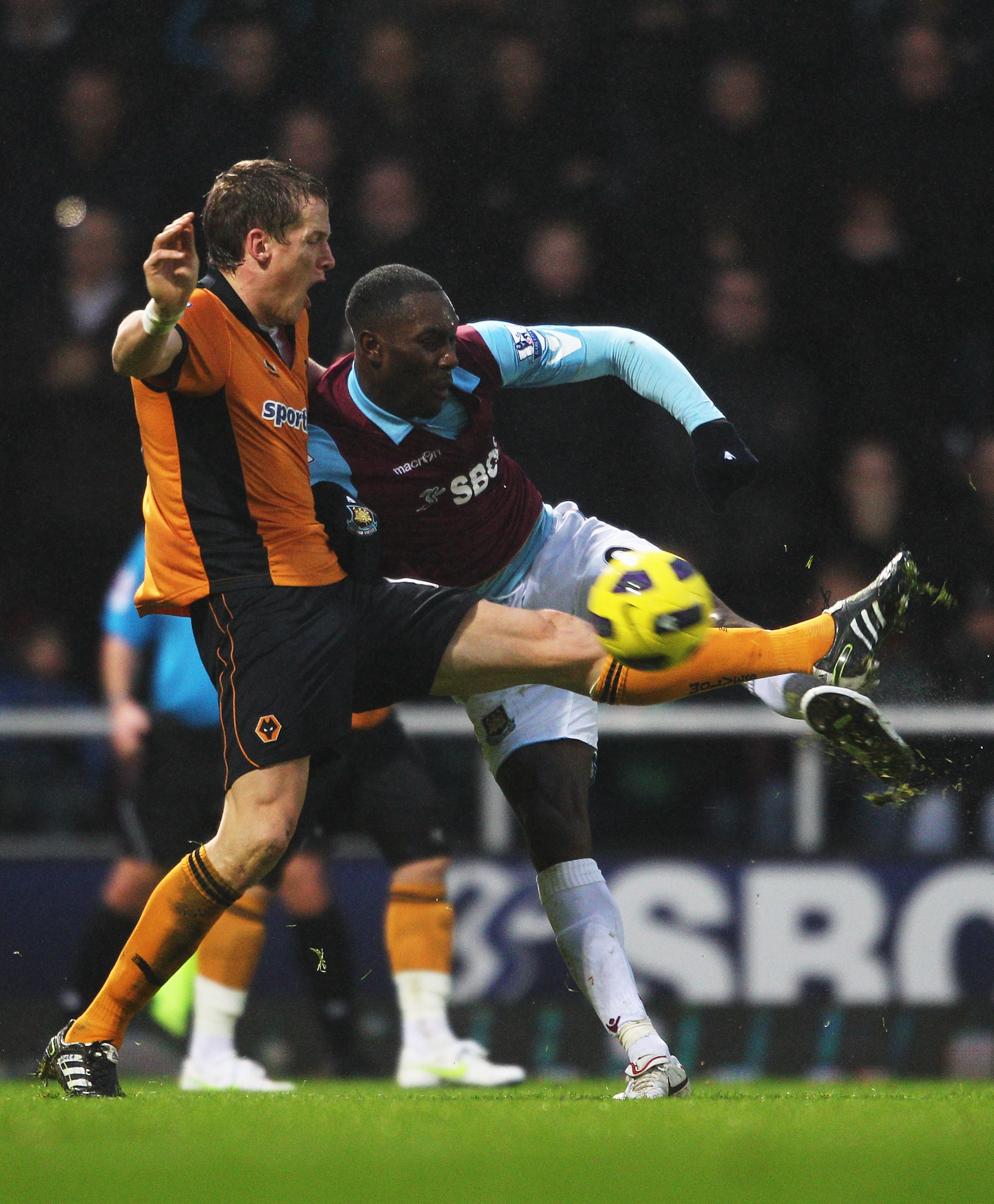 LONDON, ENGLAND - JANUARY 01:  Carlton Cole of West Ham United is challenged by Christophe Berra of Wolverhampton Wanderers during the Barclays Premier League match between West Ham United and Wolverhampton Wanderers at the Boleyn Ground on January 1, 201