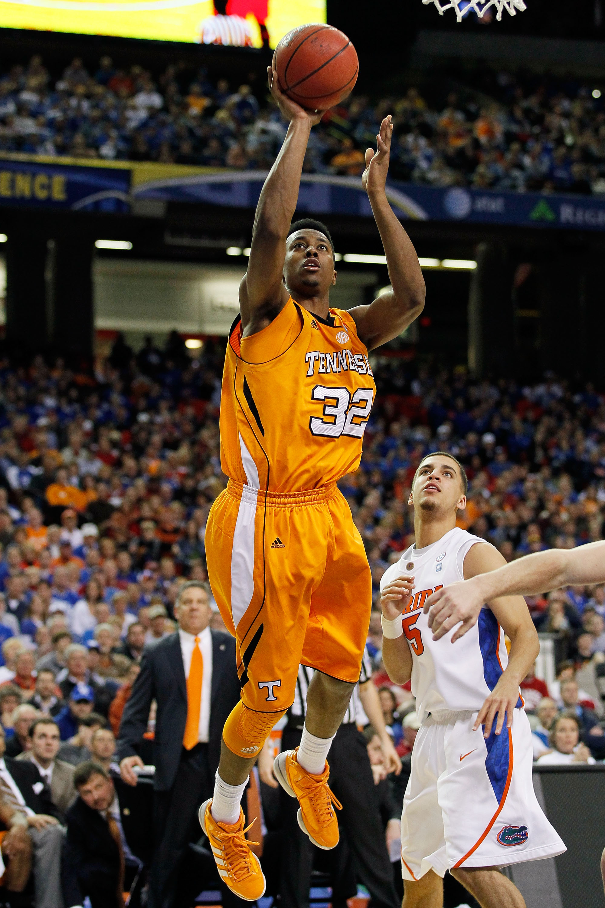 ATLANTA, GA - MARCH 11: Scotty Hopson #32 of the Tennessee Volunteers shoots over Scottie Wilbekin #5 of the Florida Gators during the quarterfinals of the SEC Men's Basketball Tournament at Georgia Dome on March 11, 2011 in Atlanta, Georgia. (Photo by