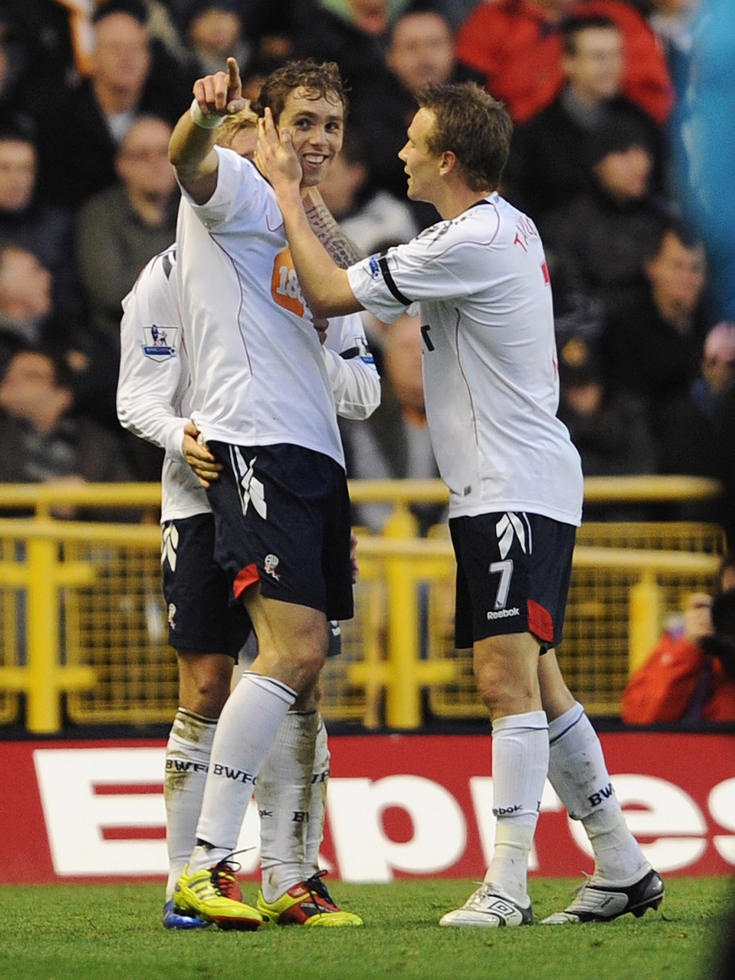 WOLVERHAMPTON, ENGLAND - NOVEMBER 13: Johan Elmander of Bolton celebrates with team-mate Matthew Taylor (R) after scoring the 2-0 goal during the Barclays Premier League match between Wolverhampton Wanderers and Bolton Wanderers at Molineux on November 13