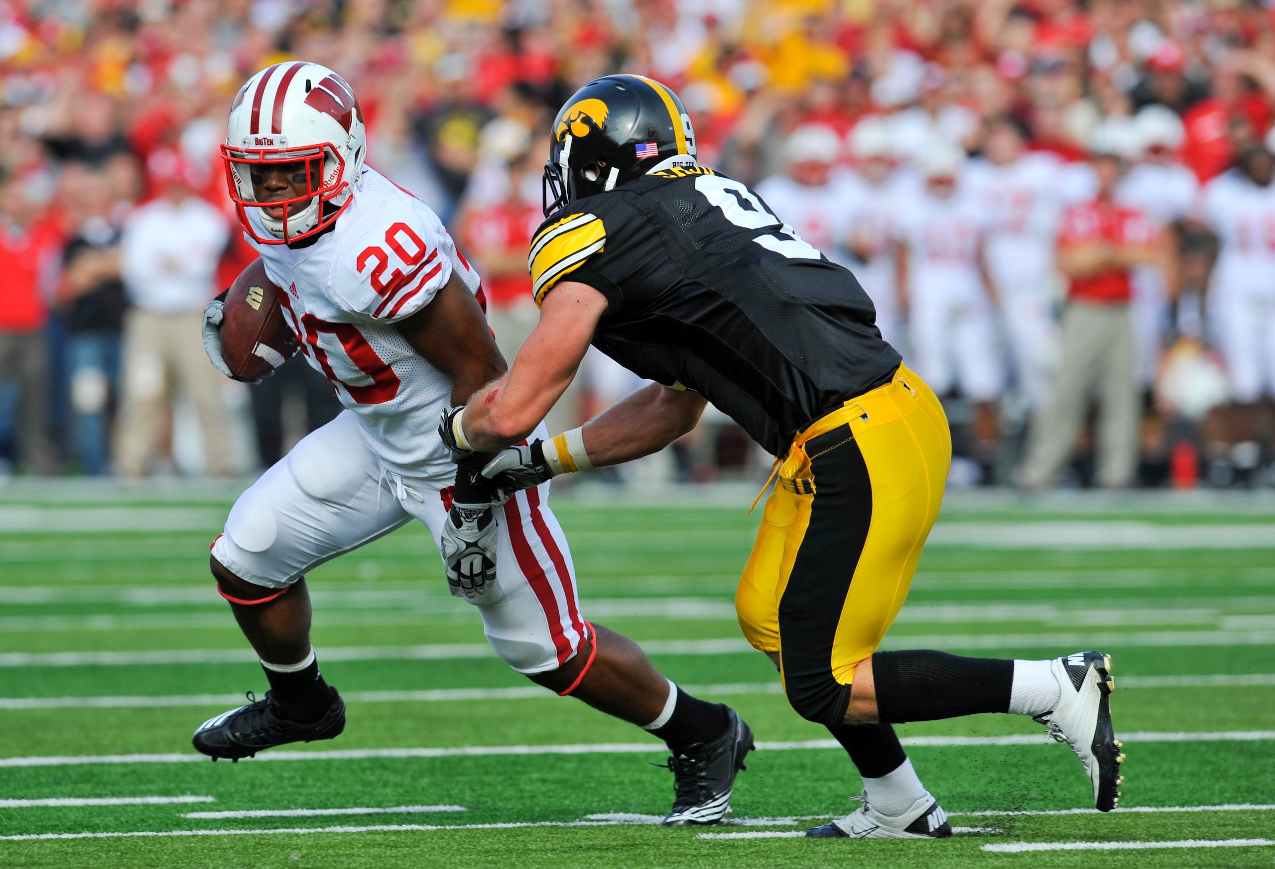 IOWA CITY, IA - OCTOBER 23: Defensive back Tyler Sash #9 of the University of Iowa Hawkeyes closes in on running back James White #20 of the Wisconsin Badgers as he rushes for yards during the first half of play at Kinnick Stadium on October 23, 2010 in I