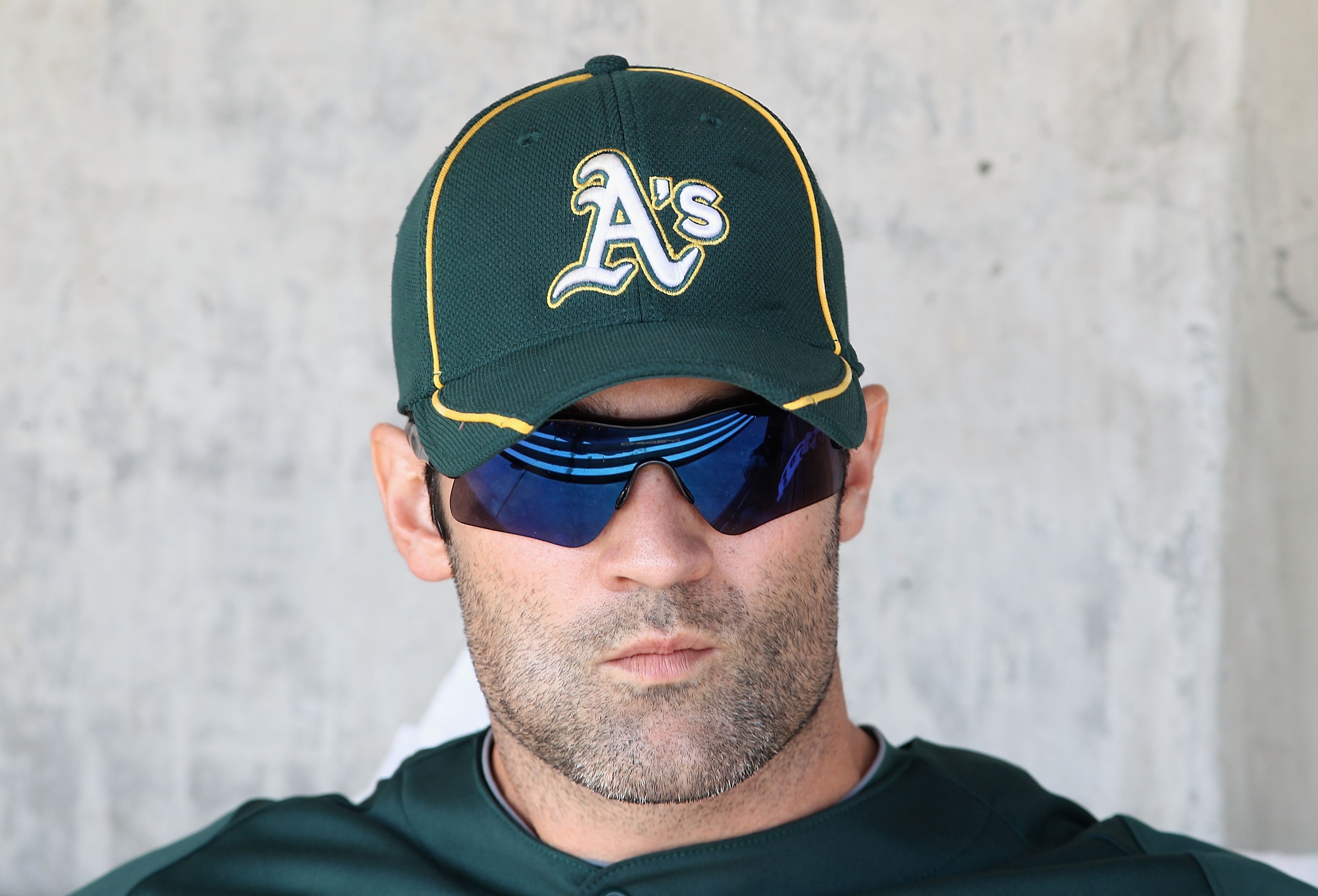 PHOENIX, AZ - MARCH 03:  Conor Jackson #28 of the Oakland Athletics sits in the dugout during the spring training game against the Milwaukee Brewers at Maryvale Baseball Park on March 3, 2011 in Phoenix, Arizona.  (Photo by Christian Petersen/Getty Images