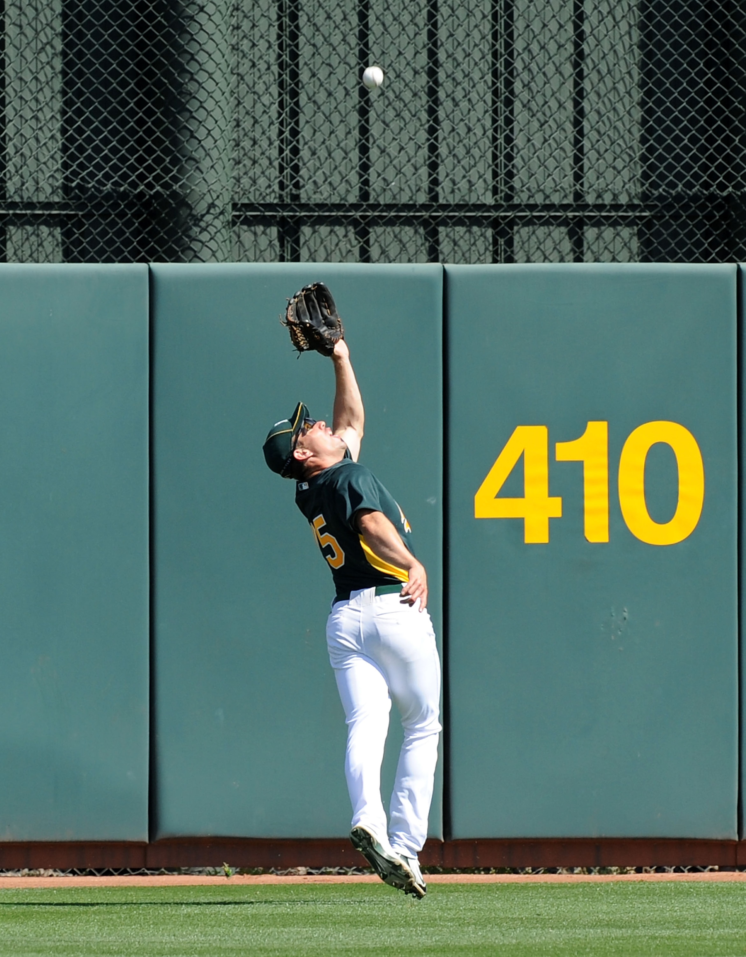 PHOENIX, AZ - MARCH 04:  Matt Carson #25 of the Oakland Athletics tracks down a fly ball against the Texas Rangers at Phoenix Municipal Stadium on March 4, 2011 in Phoenix, Arizona.  (Photo by Norm Hall/Getty Images)