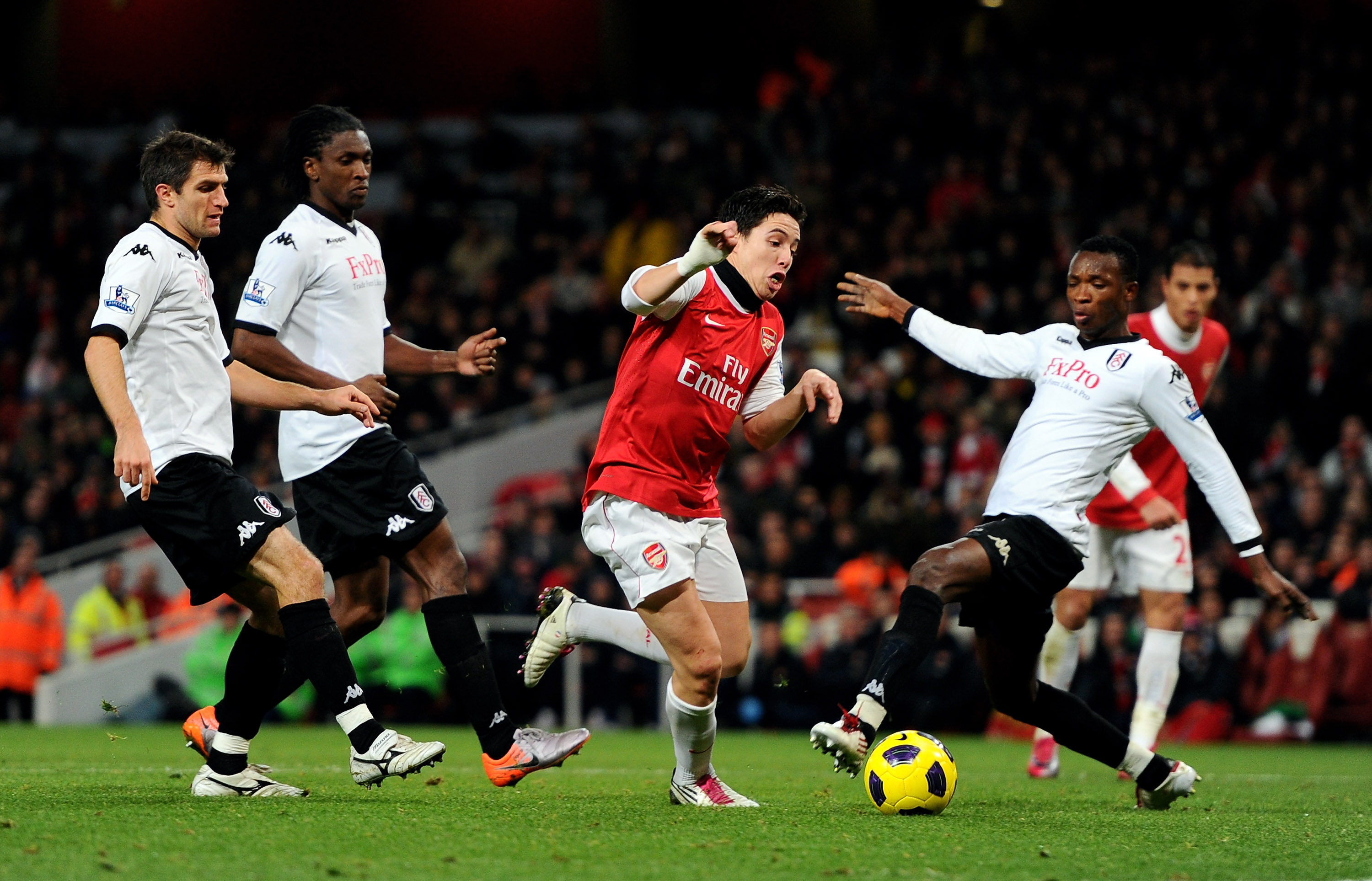 LONDON, ENGLAND - DECEMBER 04: Samir Nasri of Arsenal takes the ball past Fulham goalkeeper Mark Schwarzer to score the winning goal during the Barclays Premier League match between Arsenal and Fulham at the Emirates Stadium on December 4, 2010 in London,