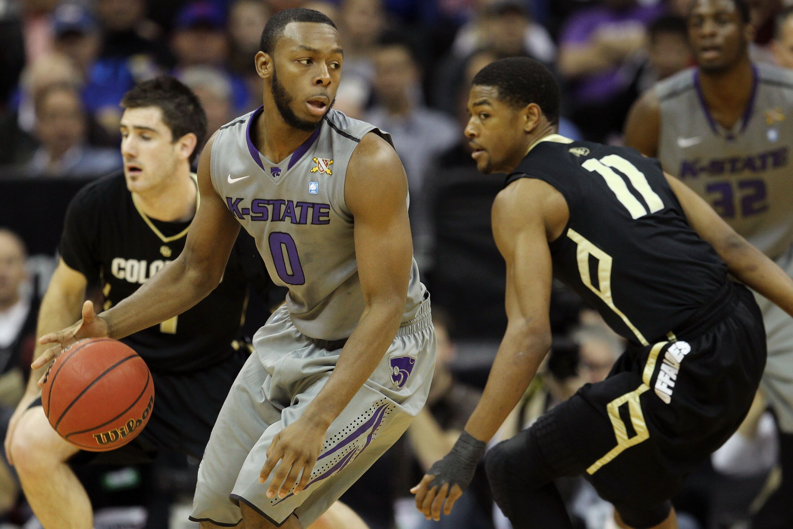 KANSAS CITY, MO - MARCH 10:  Jacob Pullen #0 of the Kansas State Wildcats looks to move the ball against the Colorado Buffaloes during their quarterfinal game in the 2011 Phillips 66 Big 12 Men's Basketball Tournament at Sprint Center on March 10, 2011 in