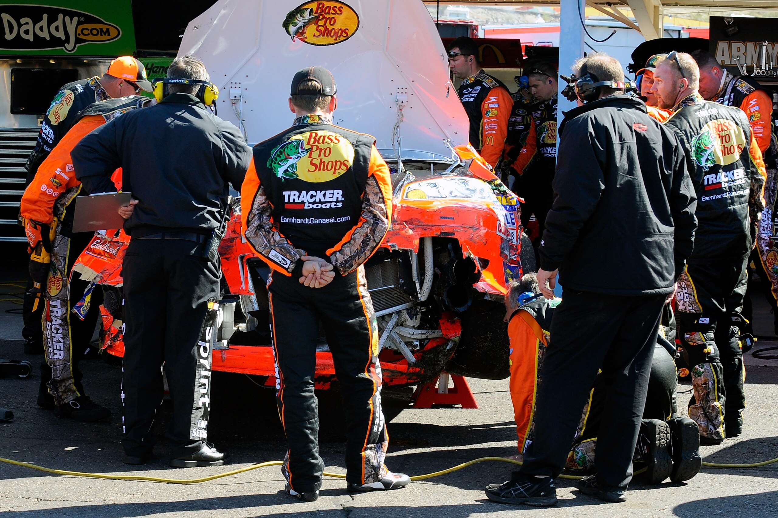 AVONDALE, AZ - FEBRUARY 27:  Jamie McMurray, driver of the #1 Bass Pro Shops Chevrolet, looks on as crew members repair damage to his car after a crash during the NASCAR Sprint Cup Series Subway Fresh Fit 500 at Phoenix International Raceway on February 2
