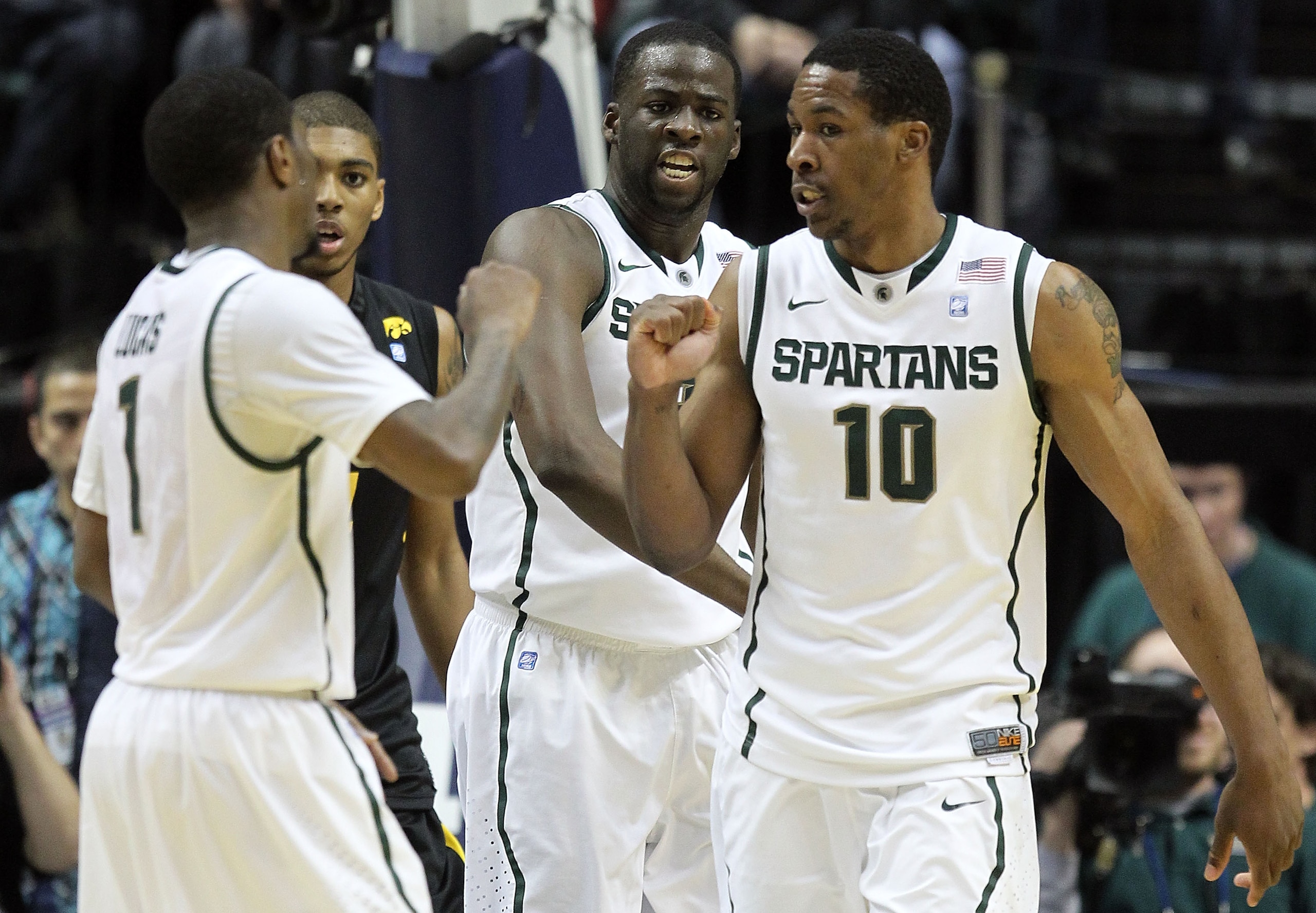 INDIANAPOLIS, IN - MARCH 10:  (L-R) Kalin Lucas #1 , Draymond Green #23 and Delvon Roe #10 of the Michigan State Spartans celebrate a play against the Iowa Hawkeyes during the first round of the 2011 Big Ten Men's Basketball Tournament at Conseco Fieldhou