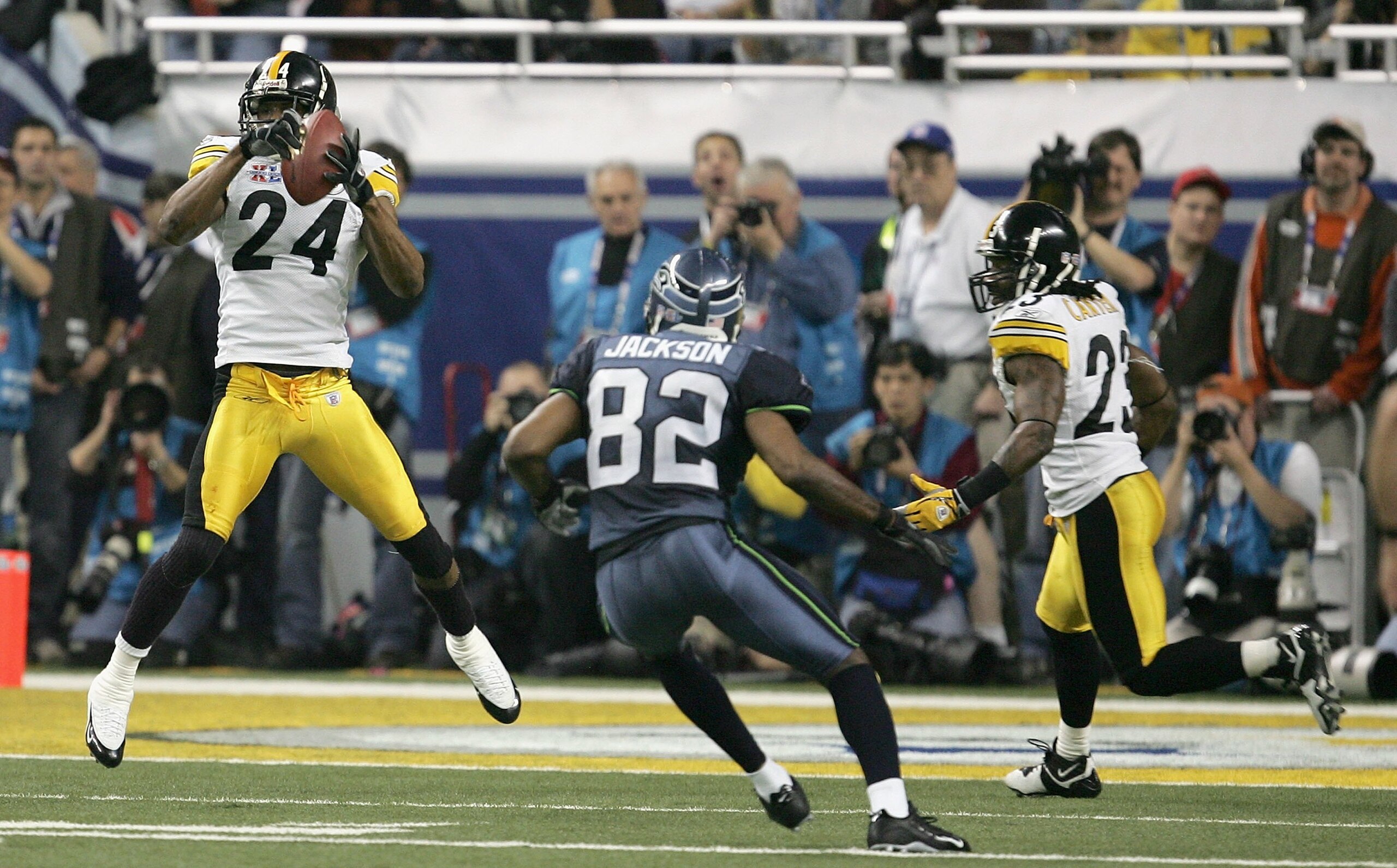 DETROIT - FEBRUARY 05:  Cornerback Ike Taylor #24 of the Pittsburgh Steelers intercepts a pass in front of wide receiver Darrel Jackson #82 of the Seattle Seahawks in the fouth quarter of Super Bowl XL at Ford Field on February 5, 2006 in Detroit, Michiga