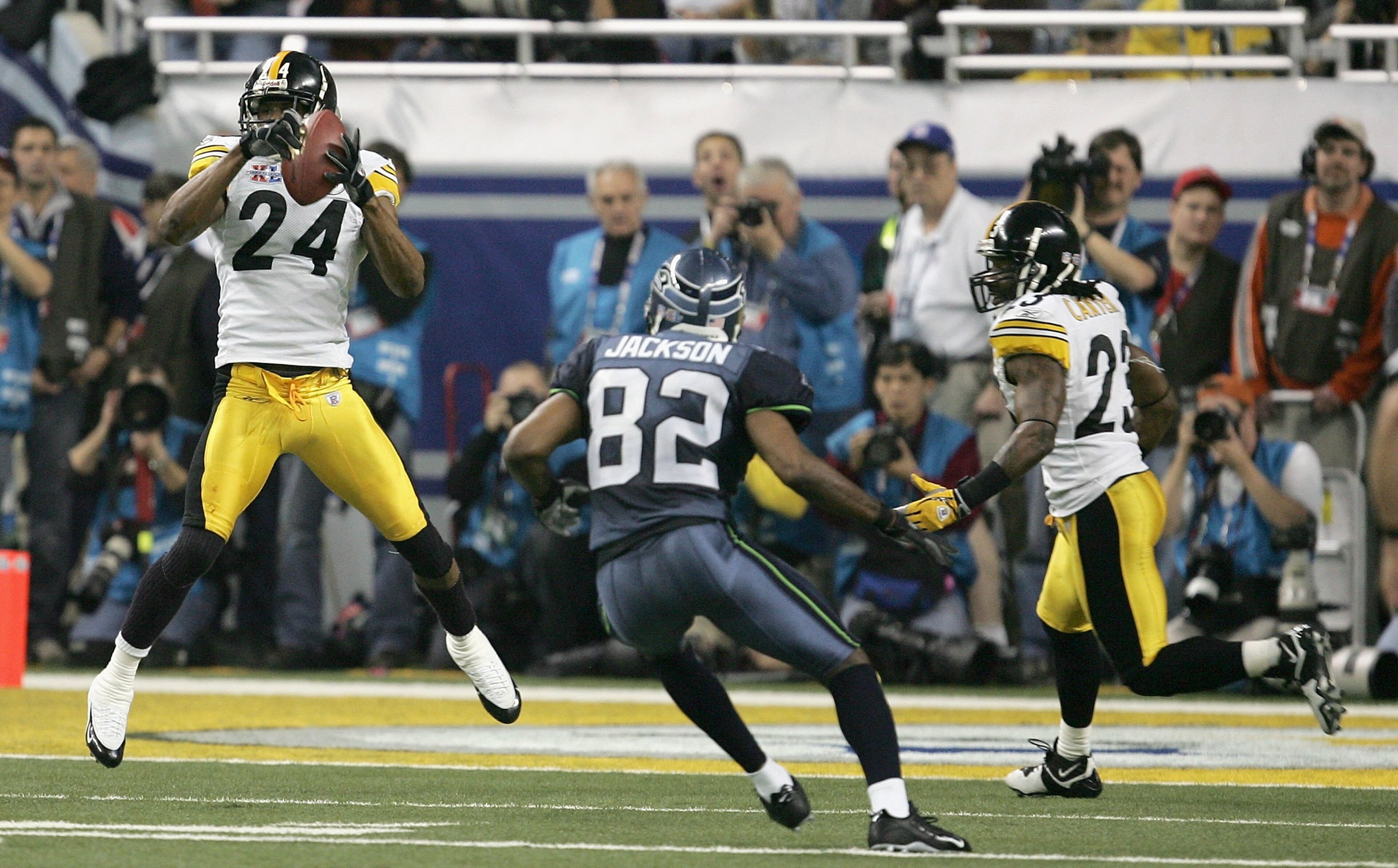 DETROIT - FEBRUARY 05:  Cornerback Ike Taylor #24 of the Pittsburgh Steelers intercepts a pass in front of wide receiver Darrel Jackson #82 of the Seattle Seahawks in the fouth quarter of Super Bowl XL at Ford Field on February 5, 2006 in Detroit, Michiga