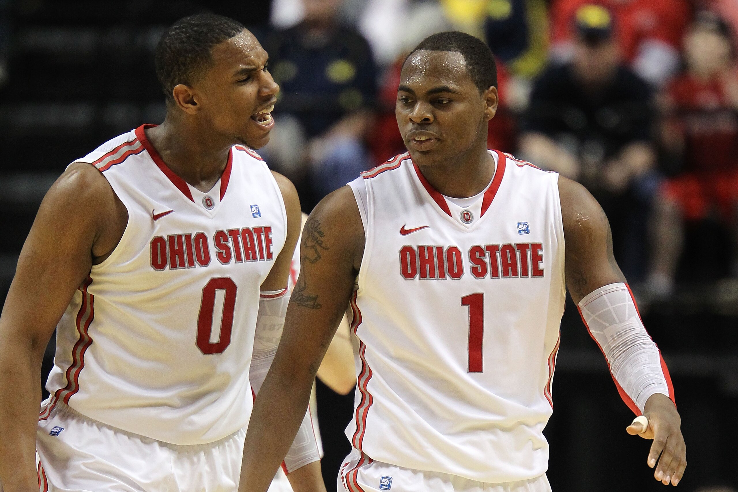 INDIANAPOLIS, IN - MARCH 12:  Jared Sullinger #0 and Deshaun Thomas #1 of the Ohio State Buckeyes react against the Michigan Wolverines during the semifinals of the 2011 Big Ten Men's Basketball Tournament at Conseco Fieldhouse on March 12, 2011 in Indian