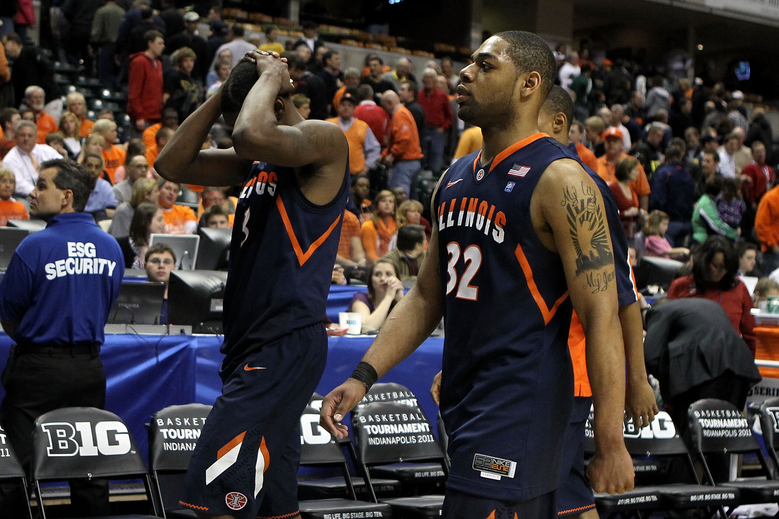 INDIANAPOLIS, IN - MARCH 11:  Demetri McCamey (R) #32 and Brandon Paul #3 of the Illinois Fighting Illini walk off the court dejected after they lost 60-55 against the Michigan Wolverines during the quarterfinals of the 2011 Big Ten Men's Basketball Tourn