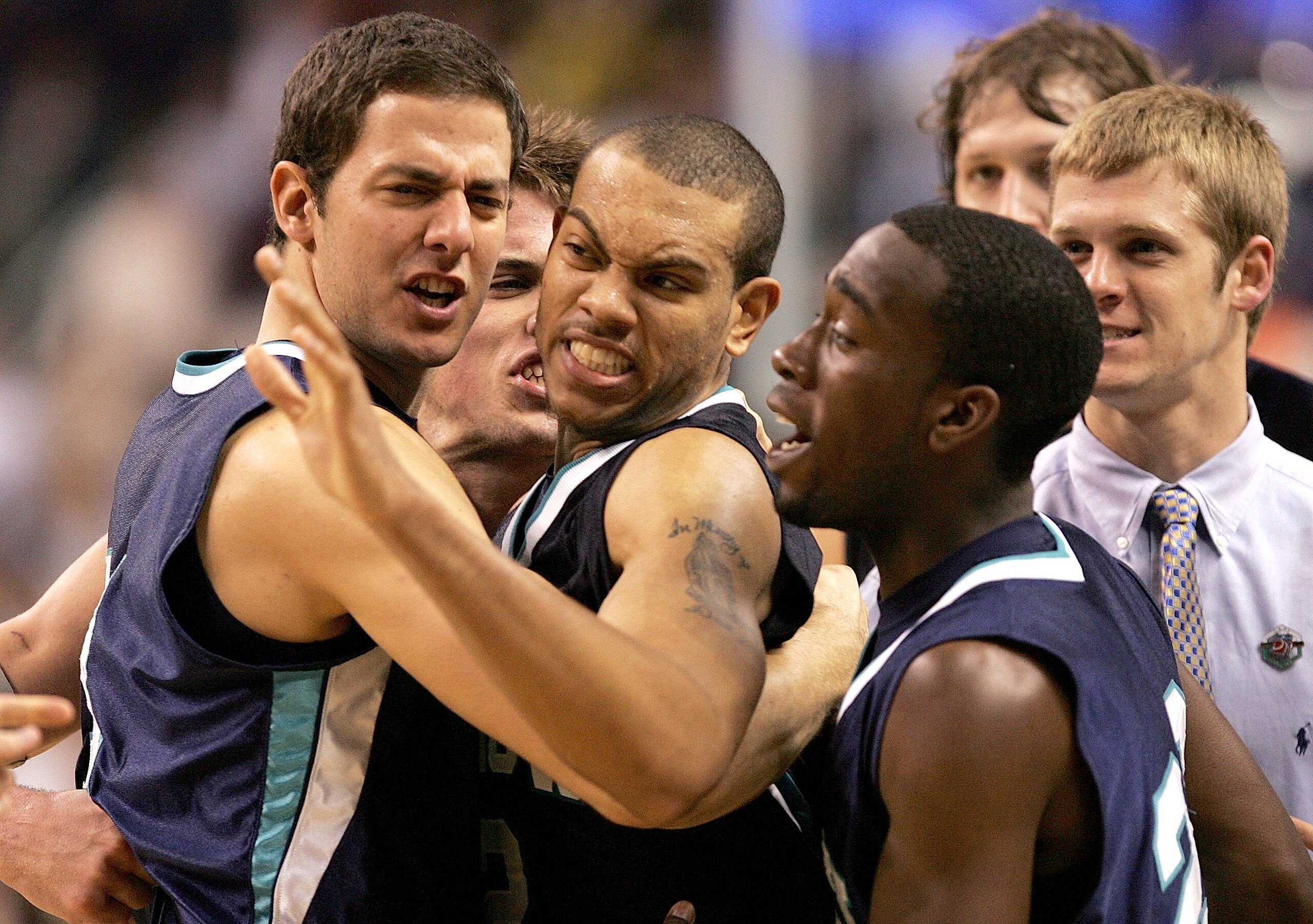 GREENSBORO, NC - MARCH 16: T.J. Carter #2 of the UNC Wilmington Seahawks is grabbed by his teammates Mitch Laue #34 and Temi Soyebo #22 after putting the Seahawks up by two points in regulation against the George Washington Colonials looks to pick him up GREENSBORO, NC - MARCH 16: T.J. Carter #2 of the UNC Wilmington Seahawks is grabbed by his teammates Mitch Laue #34 and Temi Soyebo #22 after putting the Seahawks up by two points in regulation against the George Washington Colonials looks to pick him up