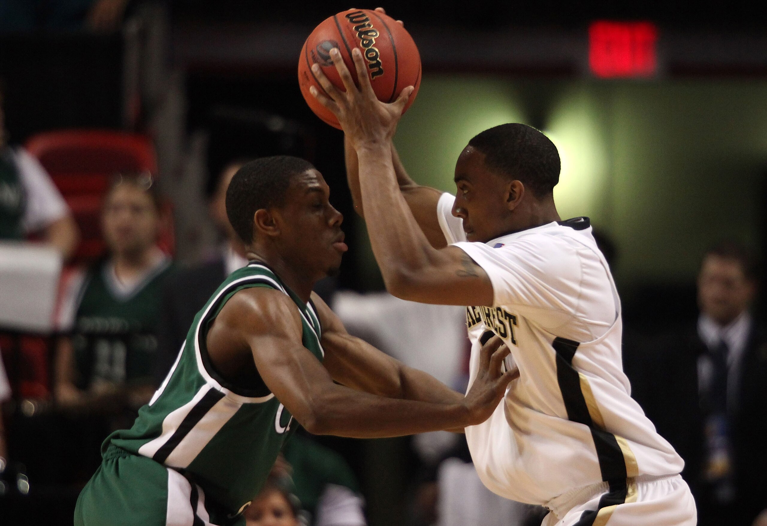MIAMI - MARCH 20: Guard Jeff Teague #0 (R) of the Wake Forest Demon Deacons is defended by guard Norris Cole #30 (L) of the Cleveland State University Vikings during the first round of the NCAA Division I Men's Basketball Tournament at the American Airlin