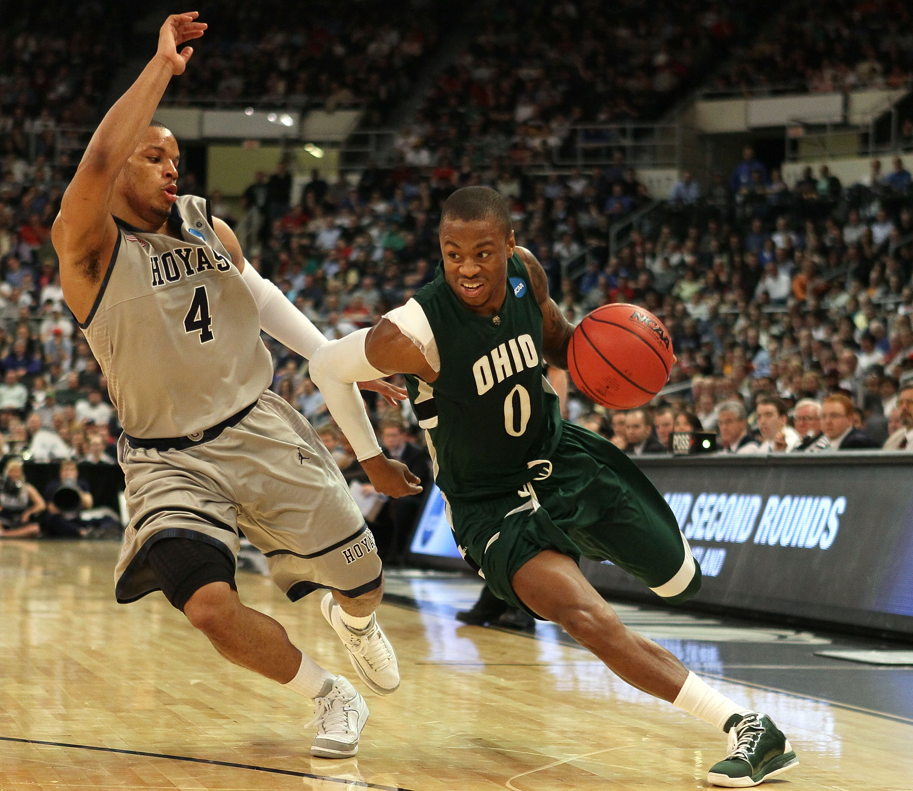 PROVIDENCE, RI - MARCH 18:  Armon Bassett #0 of the Ohio Bobcats drives to the net as Chris Wright #4 of the Georgetown Hoyas defends during the first round of the 2010 NCAA men's basketball tournament on March 18, 2010 at the Dunkin Donuts Arena in Provi