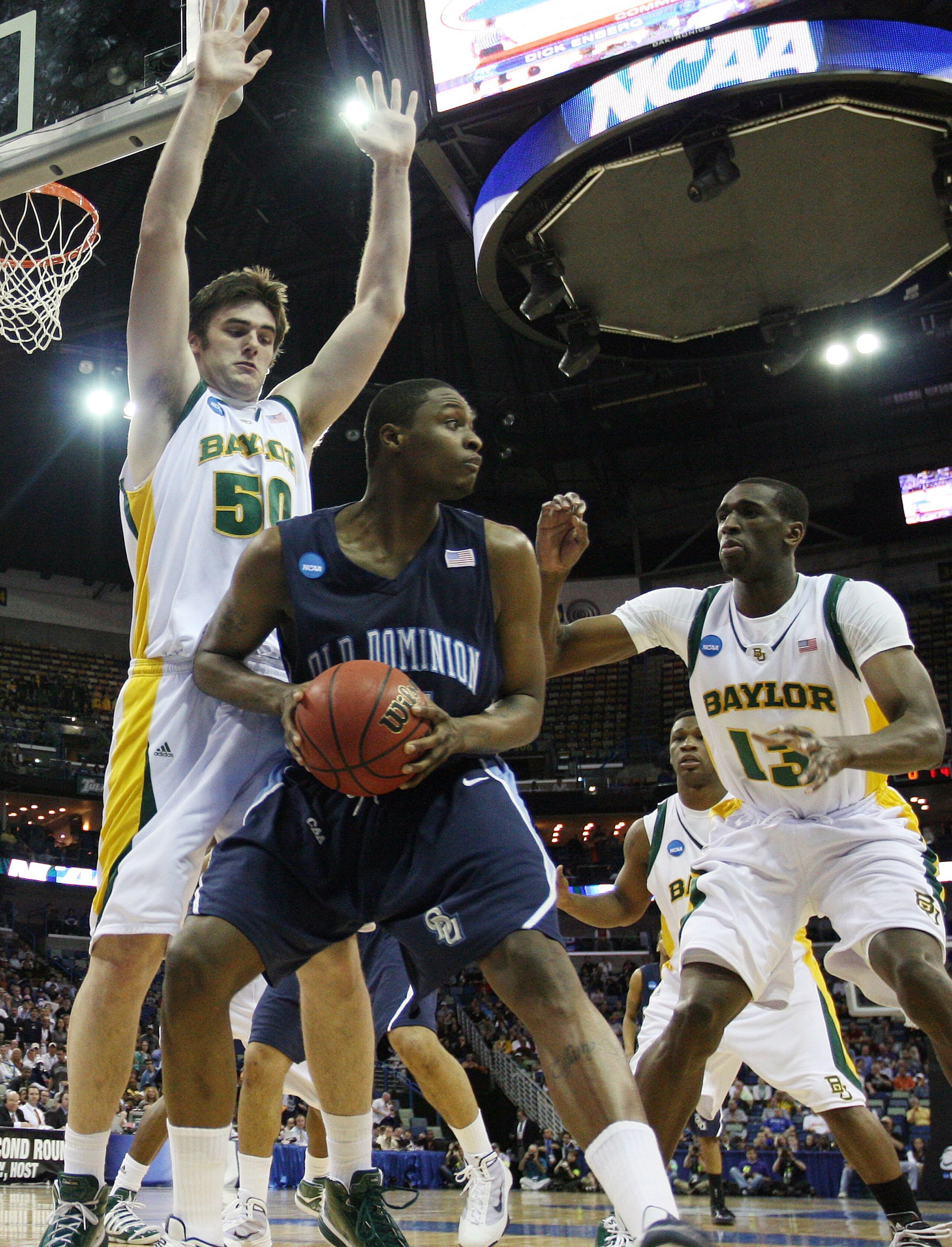 NEW ORLEANS - MARCH 20: Josh Lomers #50 and Ekpe Udoh #13  of the Baylor Bears guards Frank Hassell #21 of the Old Dominion Monarchs during the second round of the 2010 NCAA men's basketball tournament at the New Orleans Arena on March 20, 2010 in New Orl