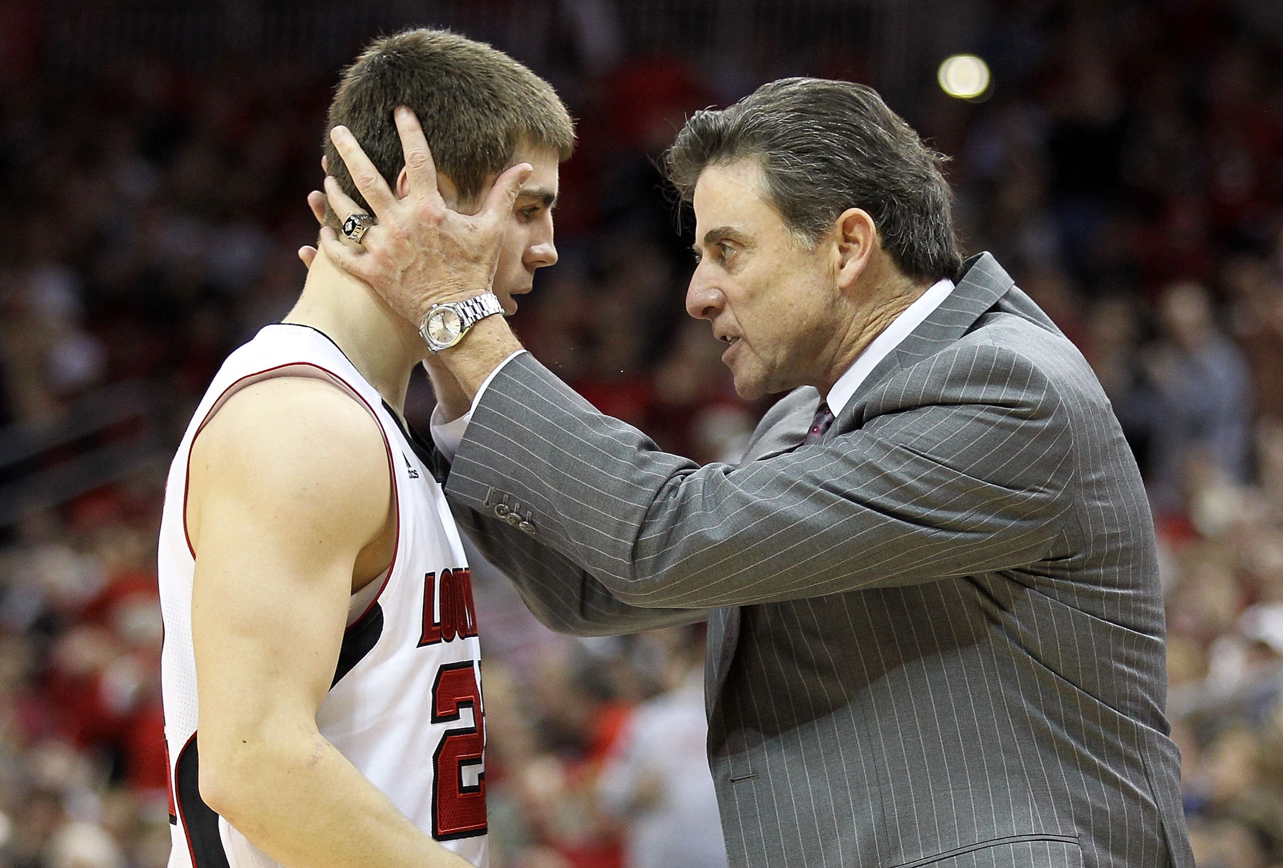LOUISVILLE, KY - JANUARY 19:  Rick Pitino the Head Coach of the Louisville Cardinals gives instructions to Elisha Justice #22 during the Big East Conference game against the St. John's Red Storm at the KFC Yum! Center on January 19, 2011 in Louisville, Ke