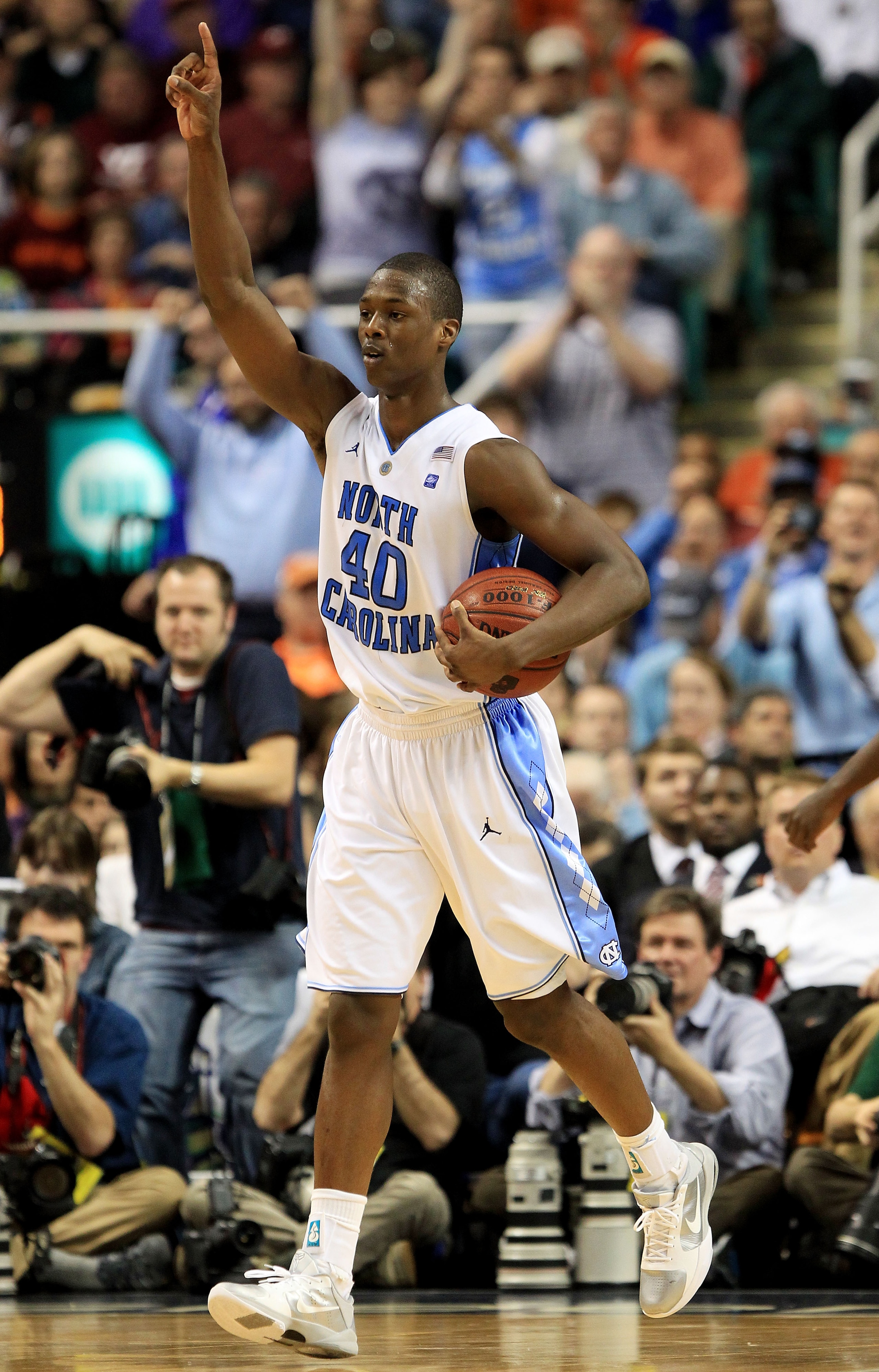 GREENSBORO, NC - MARCH 12:  Harrison Barnes #40 of the North Carolina Tar Heels celebrates their 92-87 win over the Clemson Tigers during overtime in the semifinals of the 2011 ACC men's basketball tournament at the Greensboro Coliseum on March 12, 2011 i