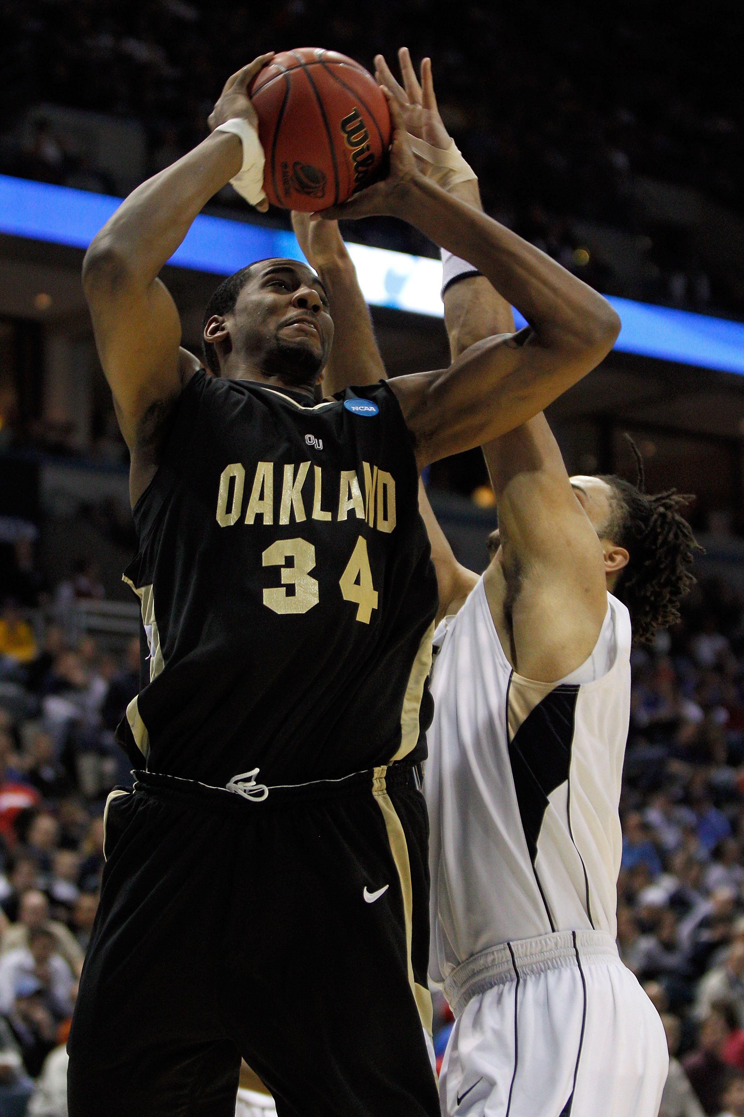 MILWAUKEE - MARCH 19:  Keith Benson #34 of the Oakland Golden Grizzlies shoots over Gary McGhee #52 of the of the Pittsburgh Panthers in the first half during the first round of the 2010 NCAA men's basketball tournament at the Bradley Center on March 19,