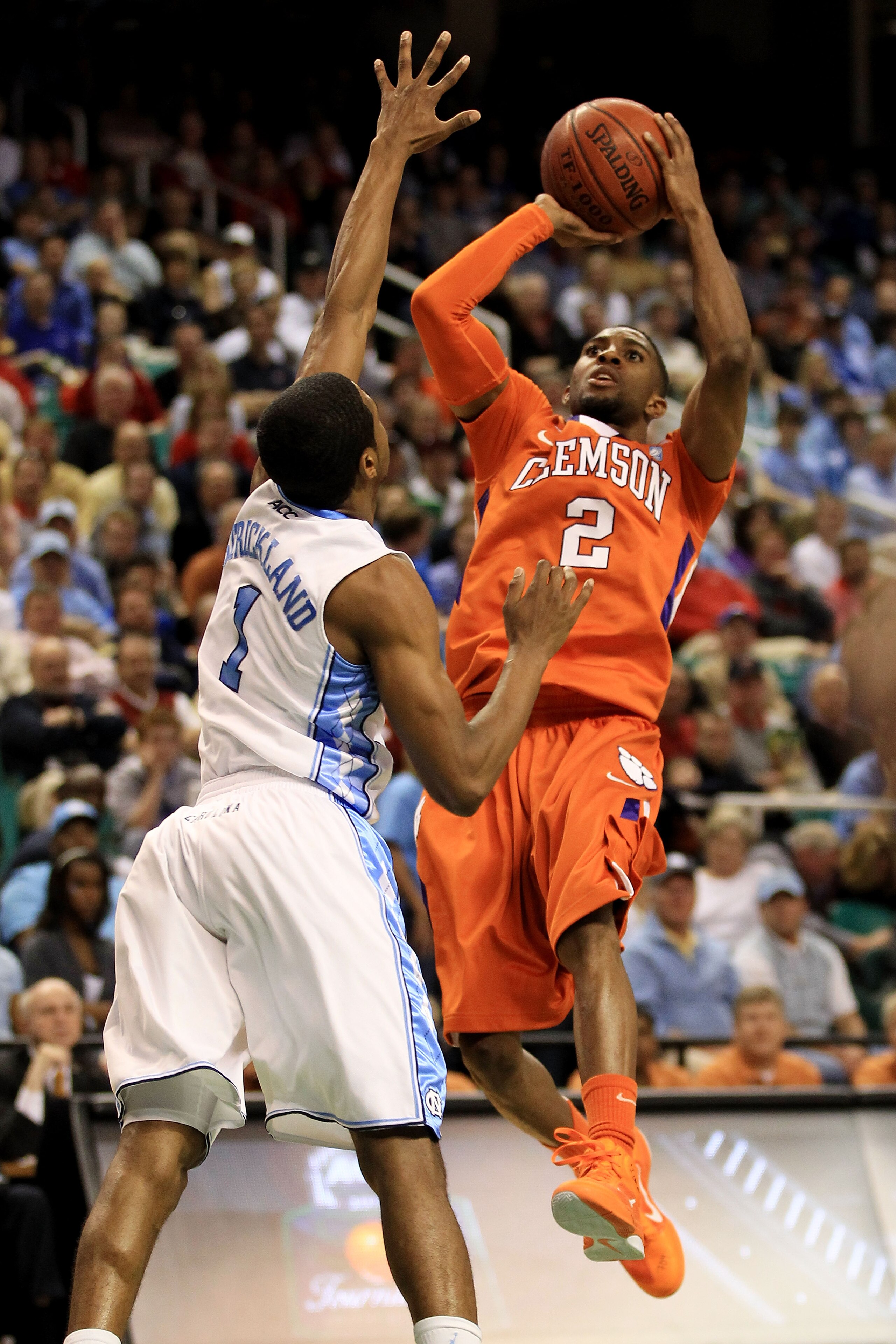 GREENSBORO, NC - MARCH 12:  Demontez Stitt #2 of the Clemson Tigers shoots against Dexter Strickland #1 of the North Carolina Tar Heels in the semifinals of the 2011 ACC men's basketball tournament at the Greensboro Coliseum on March 12, 2011 in Greensbor