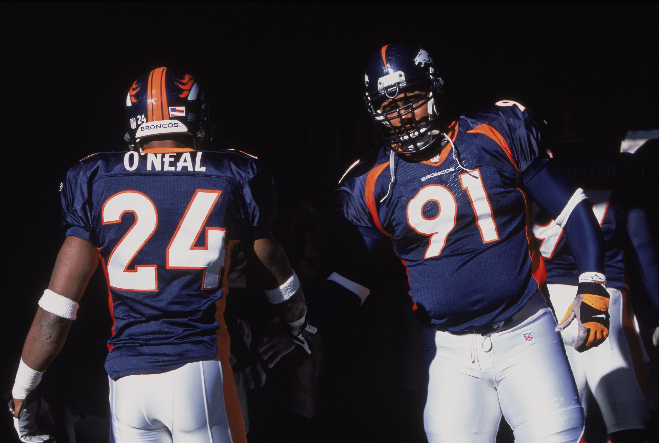 11 Nov 2001:  Defensive Tackle Chester McGlockton #91 of the Denver Broncos shaking the hand of Corner Back Deltha O''Neal #24 before the game against the San Diego Chargers at the Mile High Stadium in Denver, Colorado. The Broncos defeated the Chargers 2