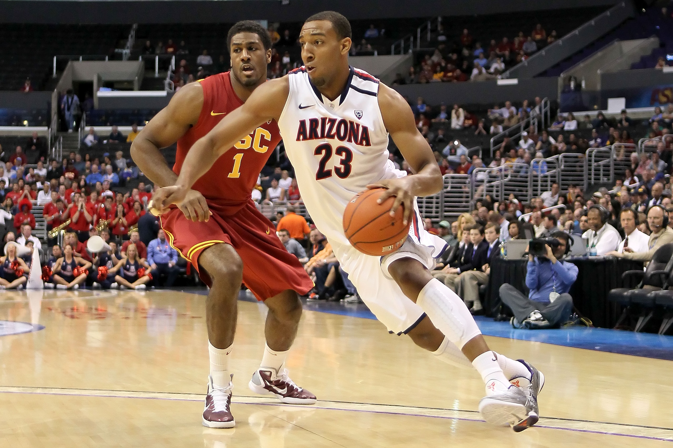 LOS ANGELES, CA - MARCH 11:  Derrick Williams #23 of the Arizona Wildcats drives on Alex Stepheson #1 of the USC Trojans in the first half in the semifinals of the 2011 Pacific Life Pac-10 Men's Basketball Tournament at Staples Center on March 11, 2011 in