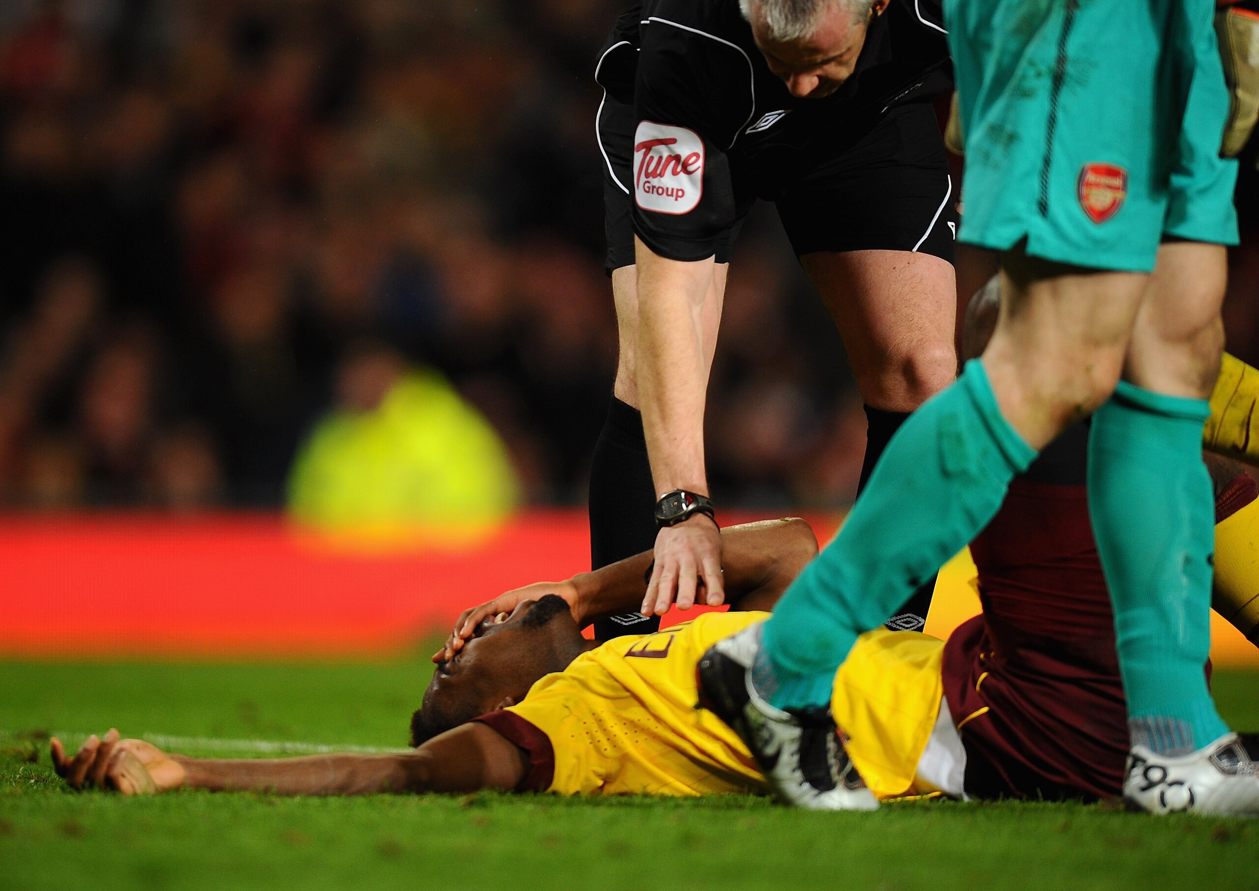 MANCHESTER, ENGLAND - MARCH 12:  Johan Djourou of Arsenal lies on the pitch in pain after disclocating his shoulder during the FA Cup sponsored by E.On Sixth Round match between Manchester United and Arsenal at Old Trafford on March 12, 2011 in Manchester