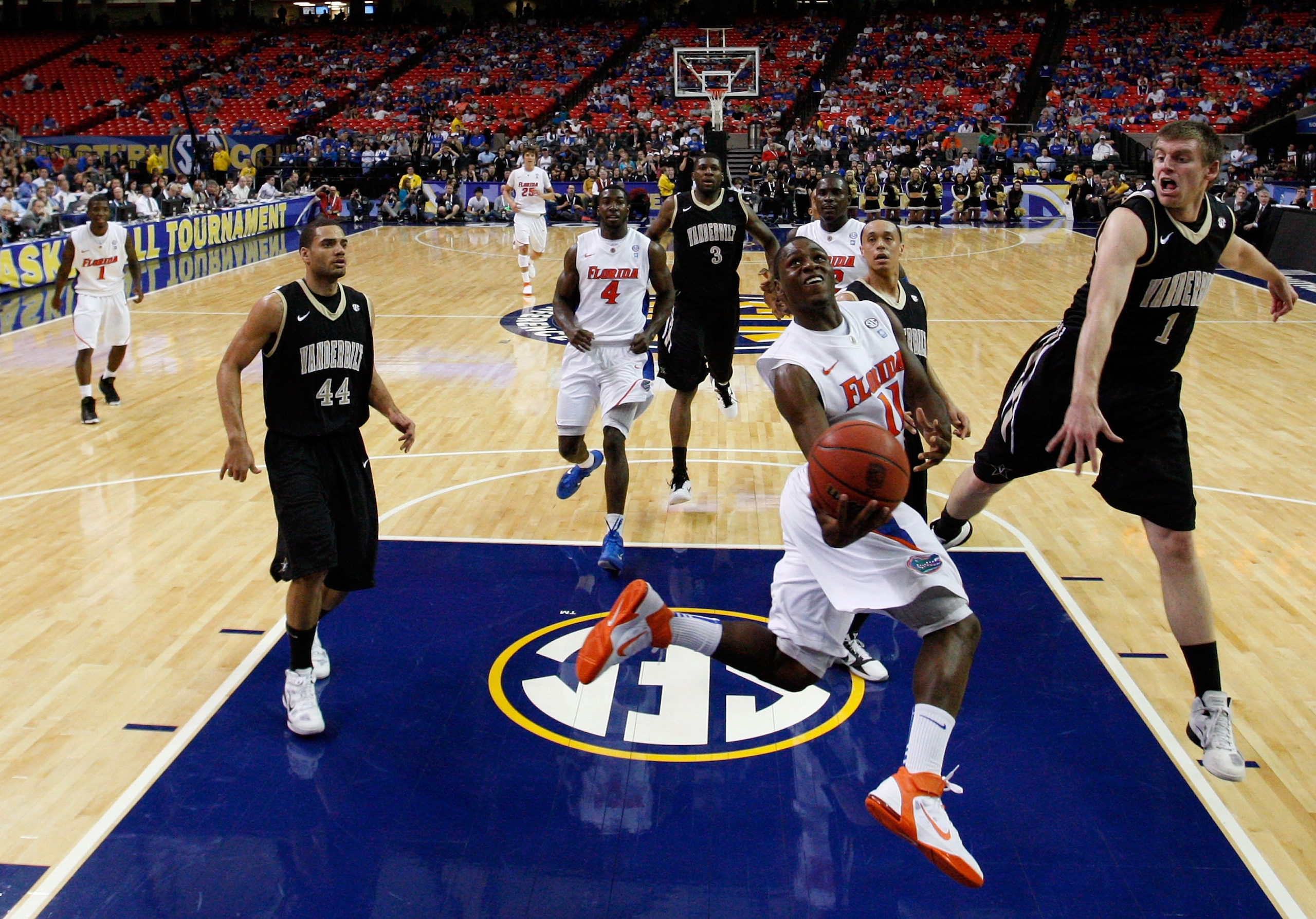 ATLANTA, GA - MARCH 12:  Erving Walker #11 of the Florida Gators shoots against Brad Tinsley #1 of the Vanderbilt Commodores during the semifinals of the SEC Men's Basketball Tournament at Georgia Dome on March 12, 2011 in Atlanta, Georgia.  (Photo by Kev