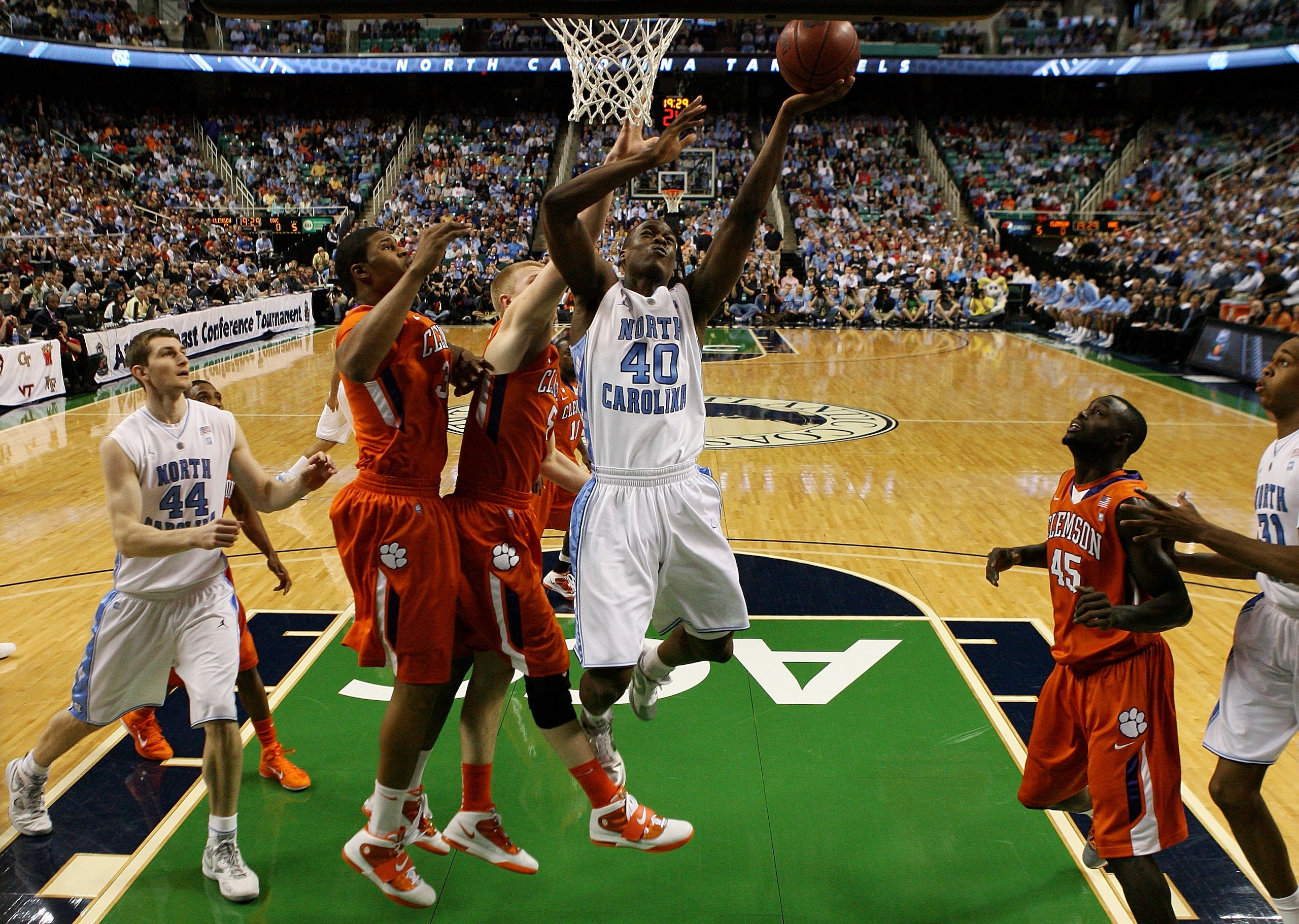 GREENSBORO, NC - MARCH 12: Harrison Barnes #40 of the North Carolina Tar Heels shoots against Tanner Smith #5 of the Clemson Tigers during the first half in the semifinals of the 2011 ACC men's basketball tournament at the Greensboro Coliseum on March 12 GREENSBORO, NC - MARCH 12: Harrison Barnes #40 of the North Carolina Tar Heels shoots against Tanner Smith #5 of the Clemson Tigers during the first half in the semifinals of the 2011 ACC men's basketball tournament at the Greensboro Coliseum on March 12