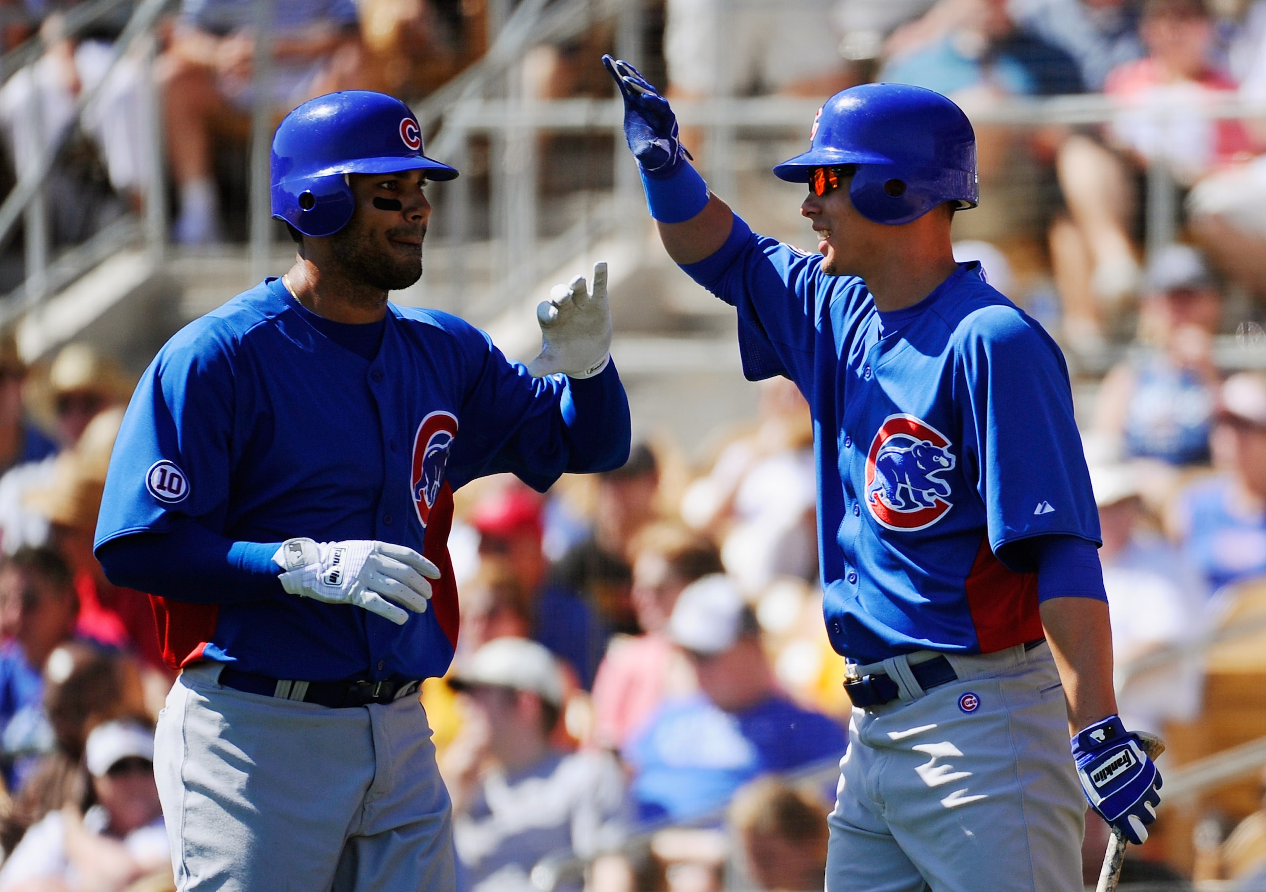 GLENDALE, AZ - MARCH 11: Carlos Pena #22 of the Chicago Cubs is congratulated by Luis Montanez #39 during the second inning of the spring training baseball game at Camelback Ranch on March 11, 2011 in Glendale, Arizona.  (Photo by Kevork Djansezian/Getty