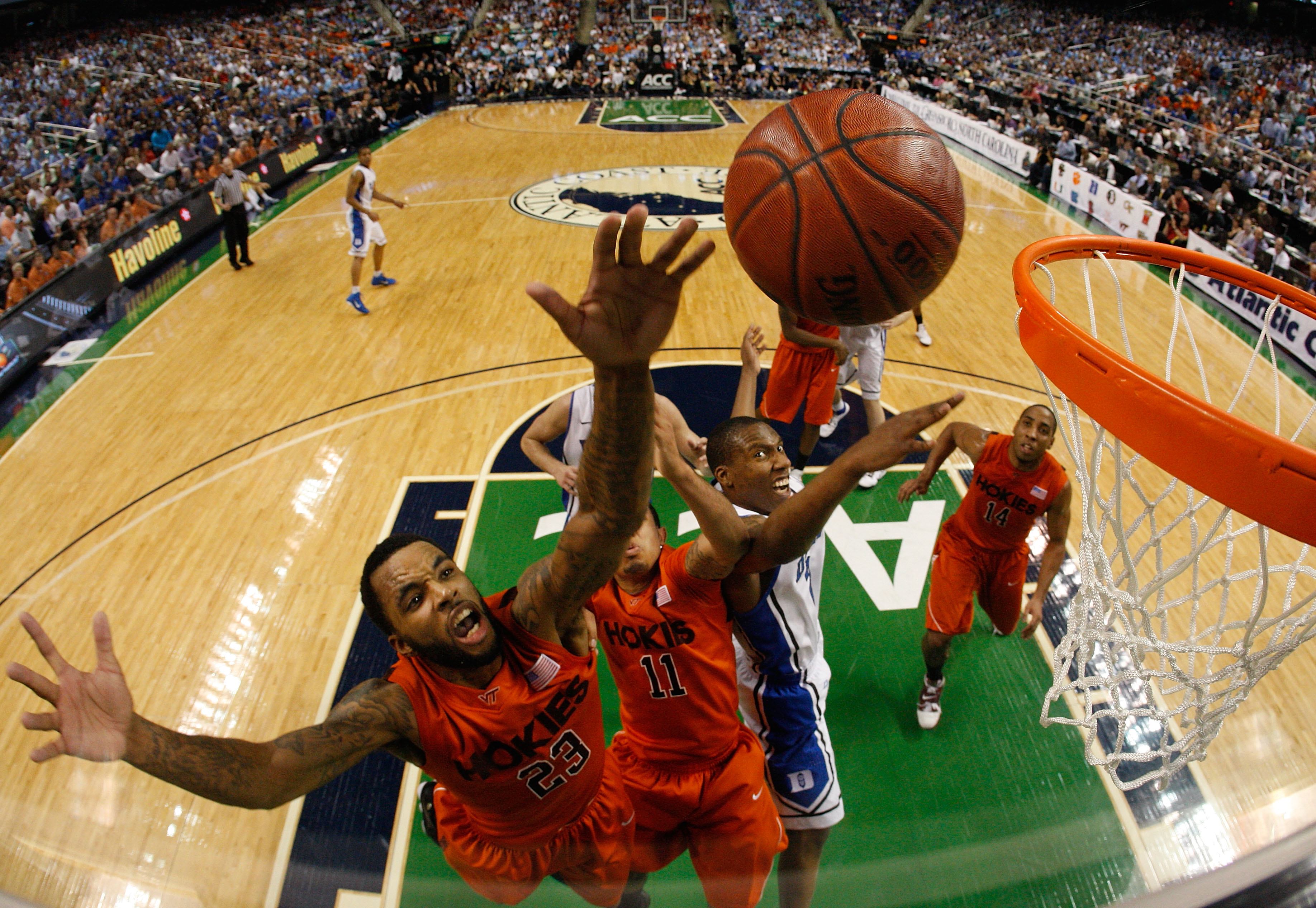 GREENSBORO, NC - MARCH 12: Malcolm Delaney #23 and Erick Green #11 of the Virginia Tech Hokies battle for a loose ball against Nolan Smith #2 of the Duke Blue Devils in the semifinals of the 2011 ACC men's basketball tournament at the Greensboro Coliseum