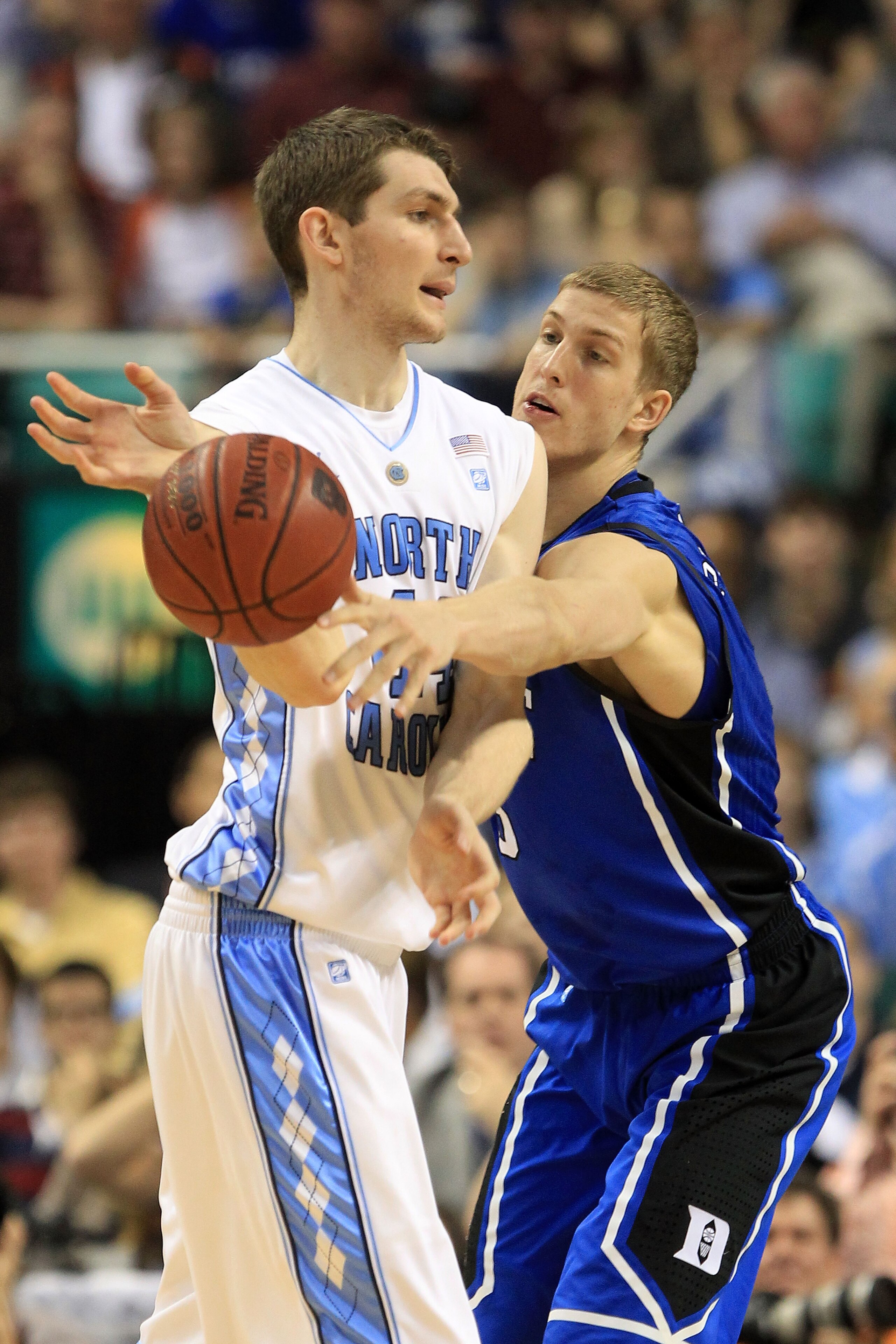 GREENSBORO, NC - MARCH 13:  Mason Plumlee #5 of the Duke Blue Devils tries to steal the ball from Tyler Zeller #44 of the North Carolina Tar Heels during the first half in the championship game of the 2011 ACC men's basketball tournament at the Greensboro