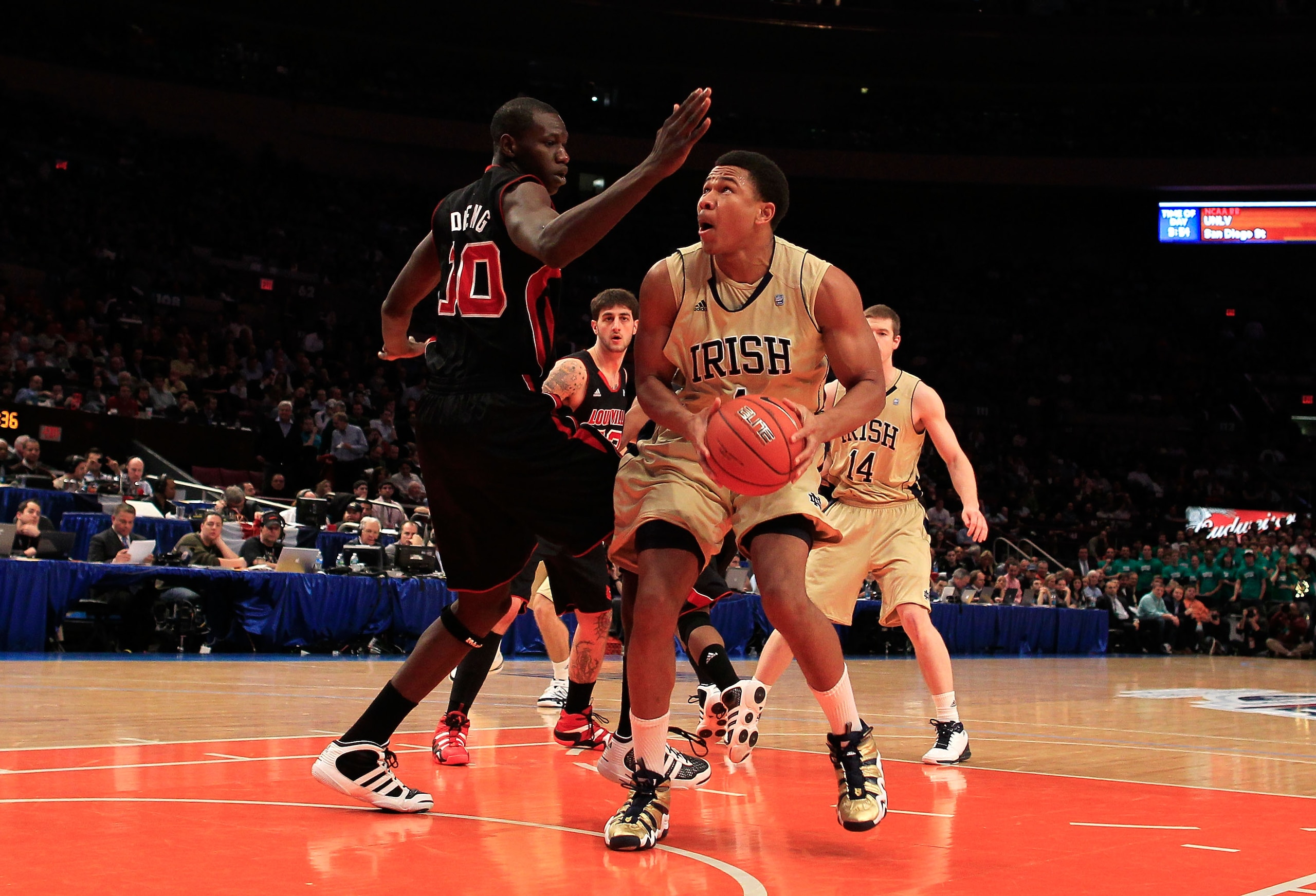 NEW YORK, NY - MARCH 11: Tyrone Nash #1 of the Notre Dame Fighting Irish drives to the basket against Gorgui Dieng #10 of the Louisville Cardinals during the semifinals of the 2011 Big East Men's Basketball Tournament presented by American Eagle Outfitter