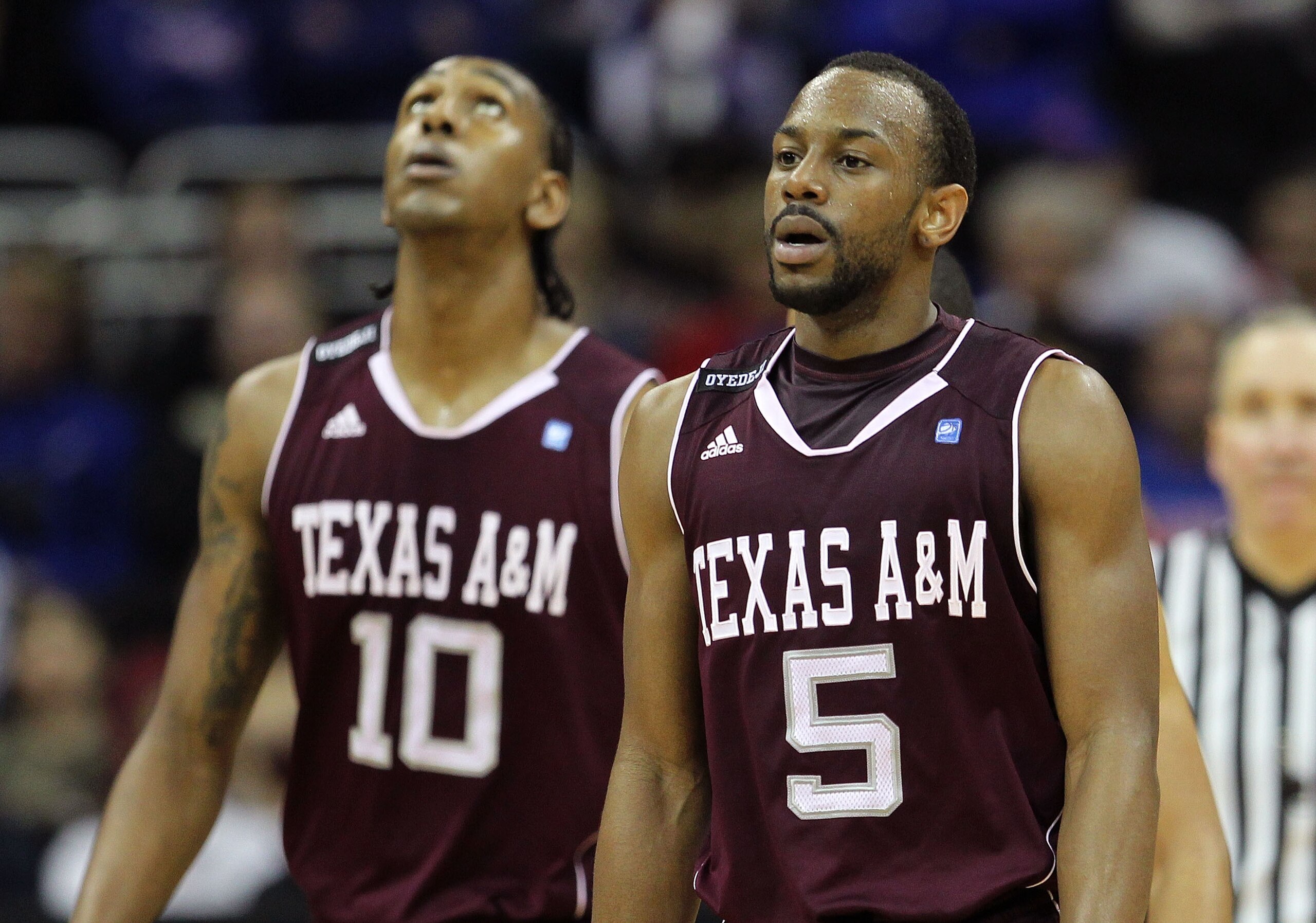 KANSAS CITY, MO - MARCH 11:  Dash Harris #5 and David Loubeau #10 of the Texas A&M Aggies walk on the court during their semifinal game against the Texas Longhorns in the 2011 Phillips 66 Big 12 Men's Basketball Tournament at Sprint Center on March 11, 20