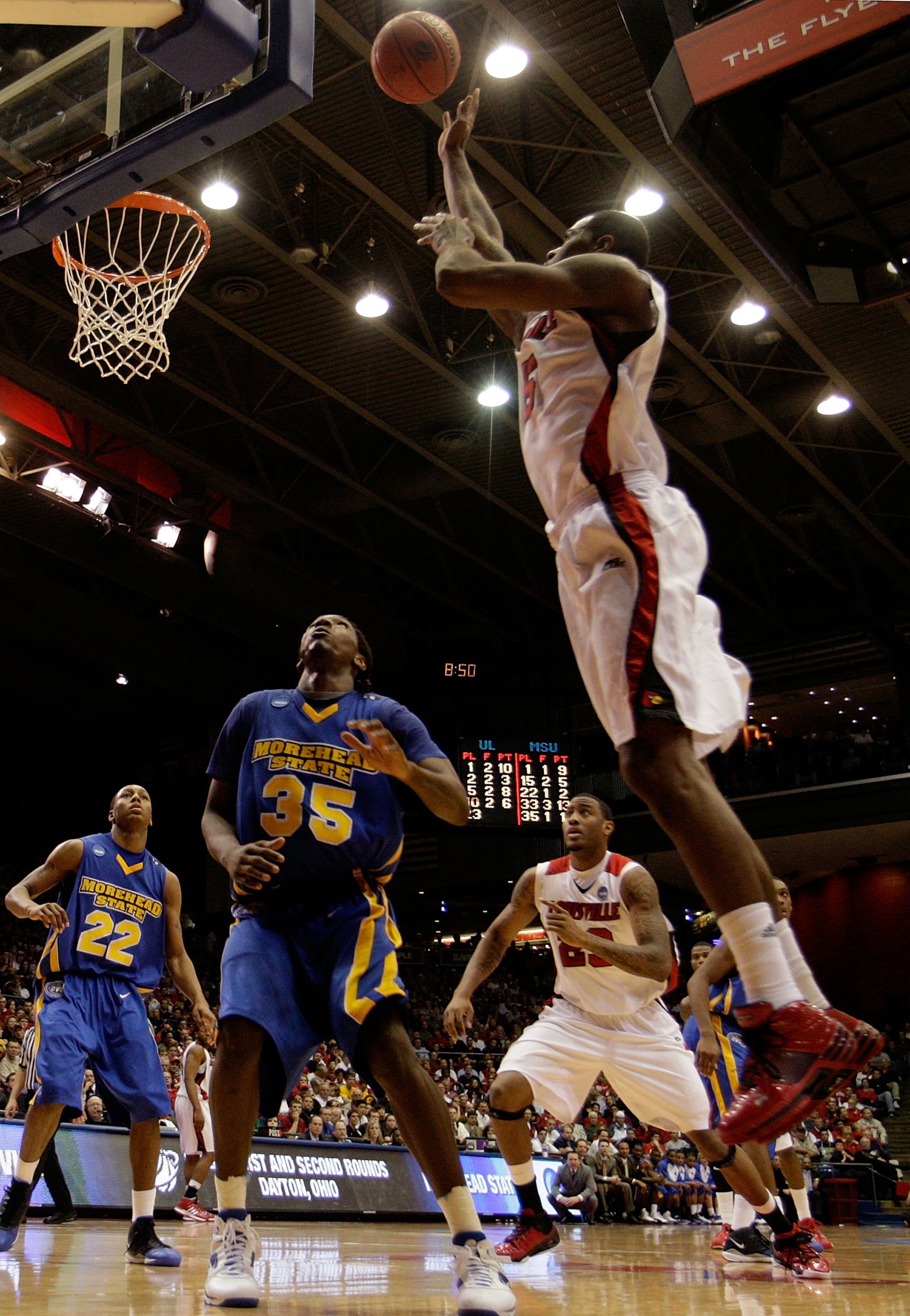 DAYTON, OH - MARCH 20: Earl Clark #5 of the Louisville Cardinals shoots over Kenneth Faried #35 of the Morehead State Eagles during the first round of the NCAA Division I Men's Basketball Tournament at the University of Dayton Arena on March 20, 2009 in D