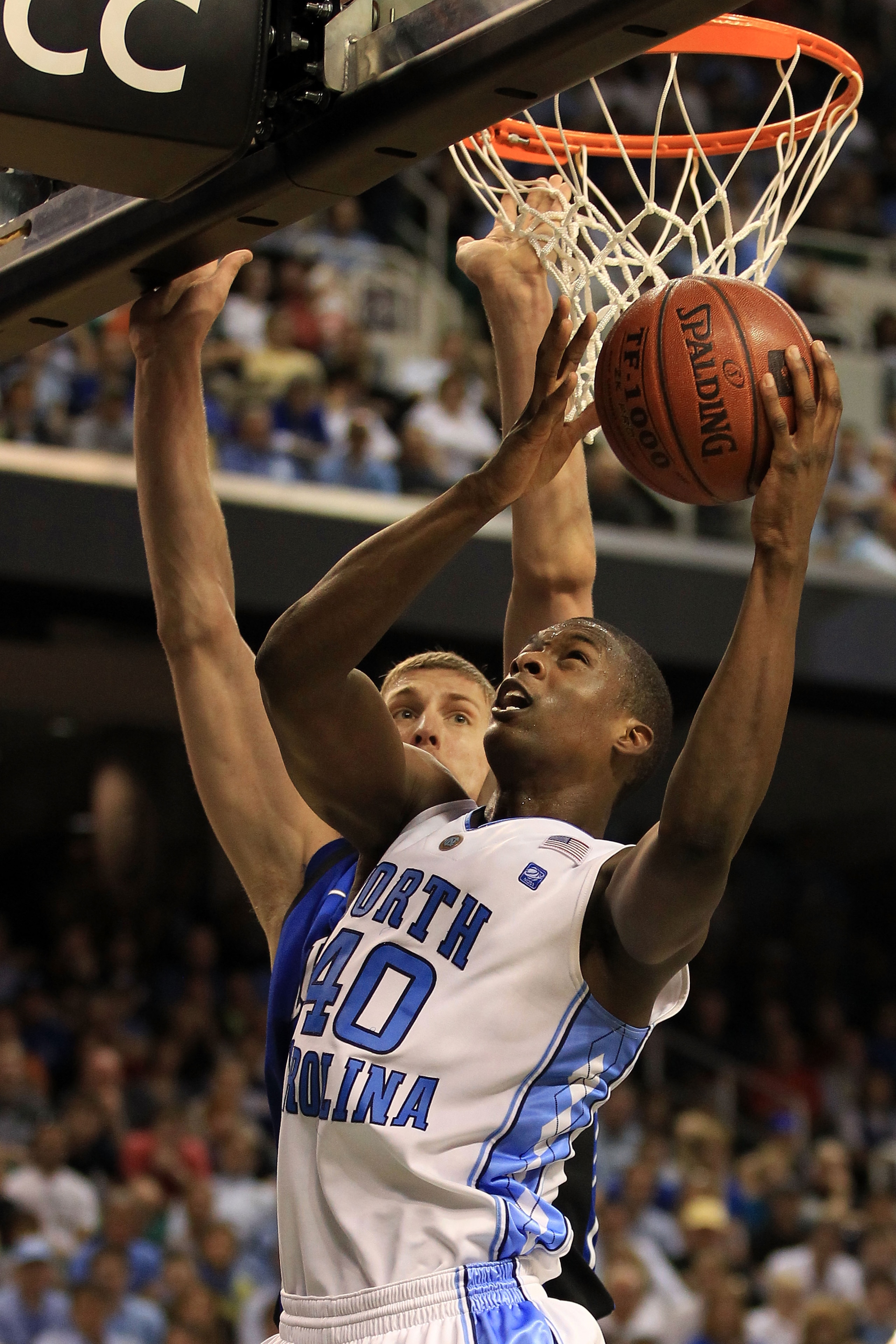 GREENSBORO, NC - MARCH 13:  Harrison Barnes #40 of the North Carolina Tar Heels shoots against Mason Plumlee #5 of the Duke Blue Devils during the second half in the championship game of the 2011 ACC men's basketball tournament at the Greensboro Coliseum 