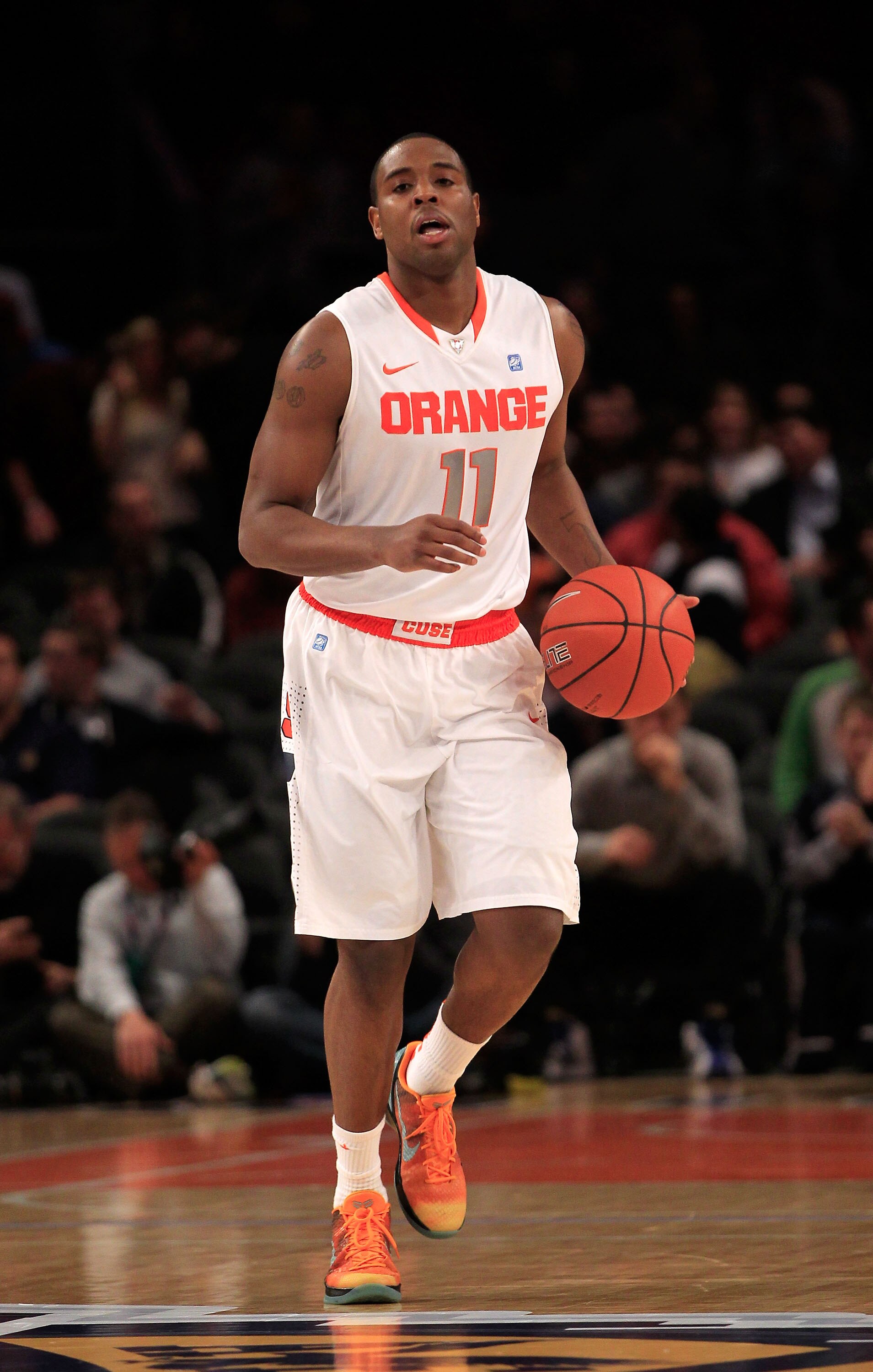 NEW YORK, NY - MARCH 11: Scoop Jardine #11 of the Syracuse Orange brings the ball up court against the Connecticut Huskies during the semifinals of the 2011 Big East Men's Basketball Tournament presented by American Eagle Outfitters at Madison Square Gard