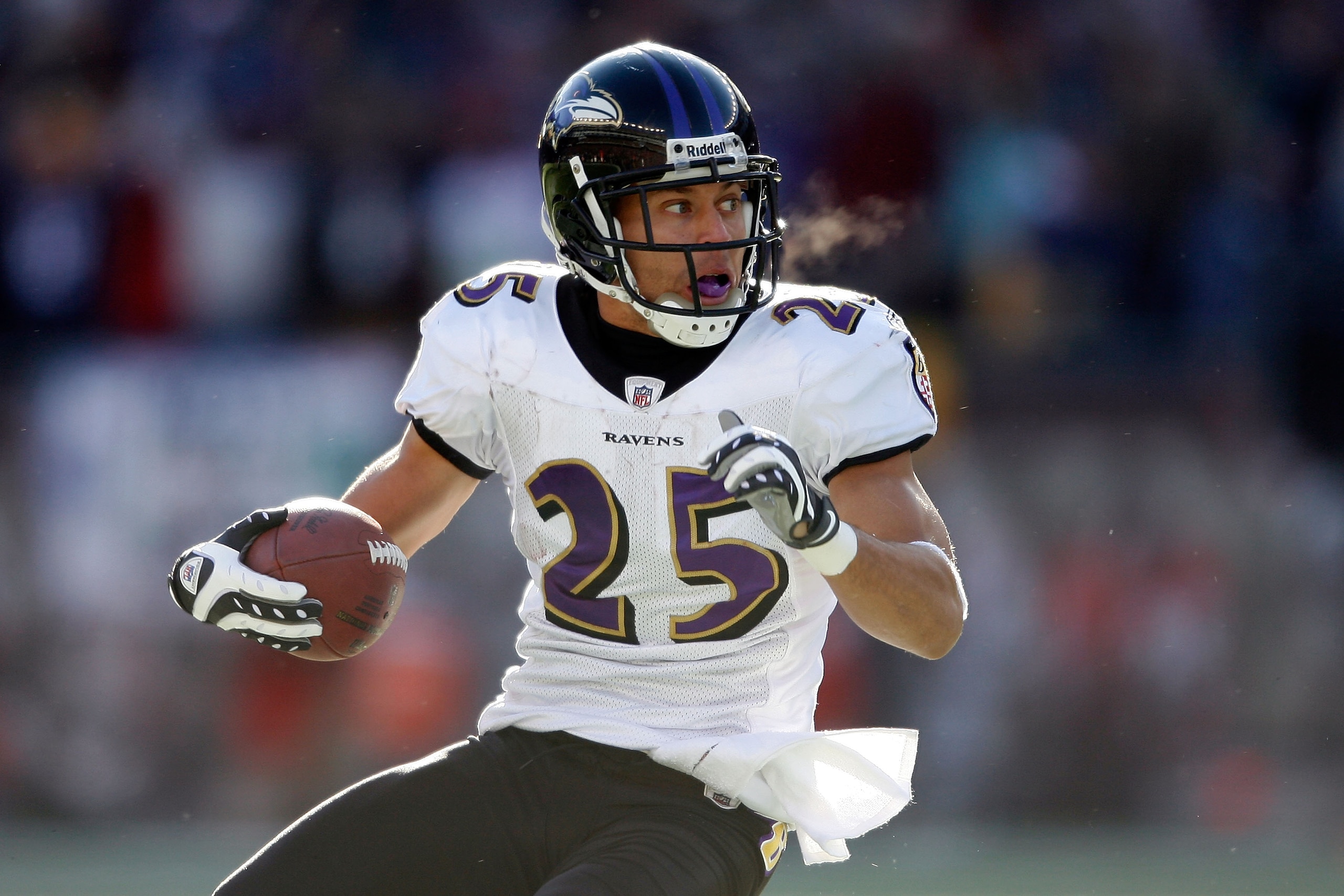 FOXBORO, MA - JANUARY 10:  Chris Carr #25 of the Baltimore Ravens runs for yards after he intercepted a pass in the first quarter against the New England Patriots during the 2010 AFC wild-card playoff game at Gillette Stadium on January 10, 2010 in Foxbor