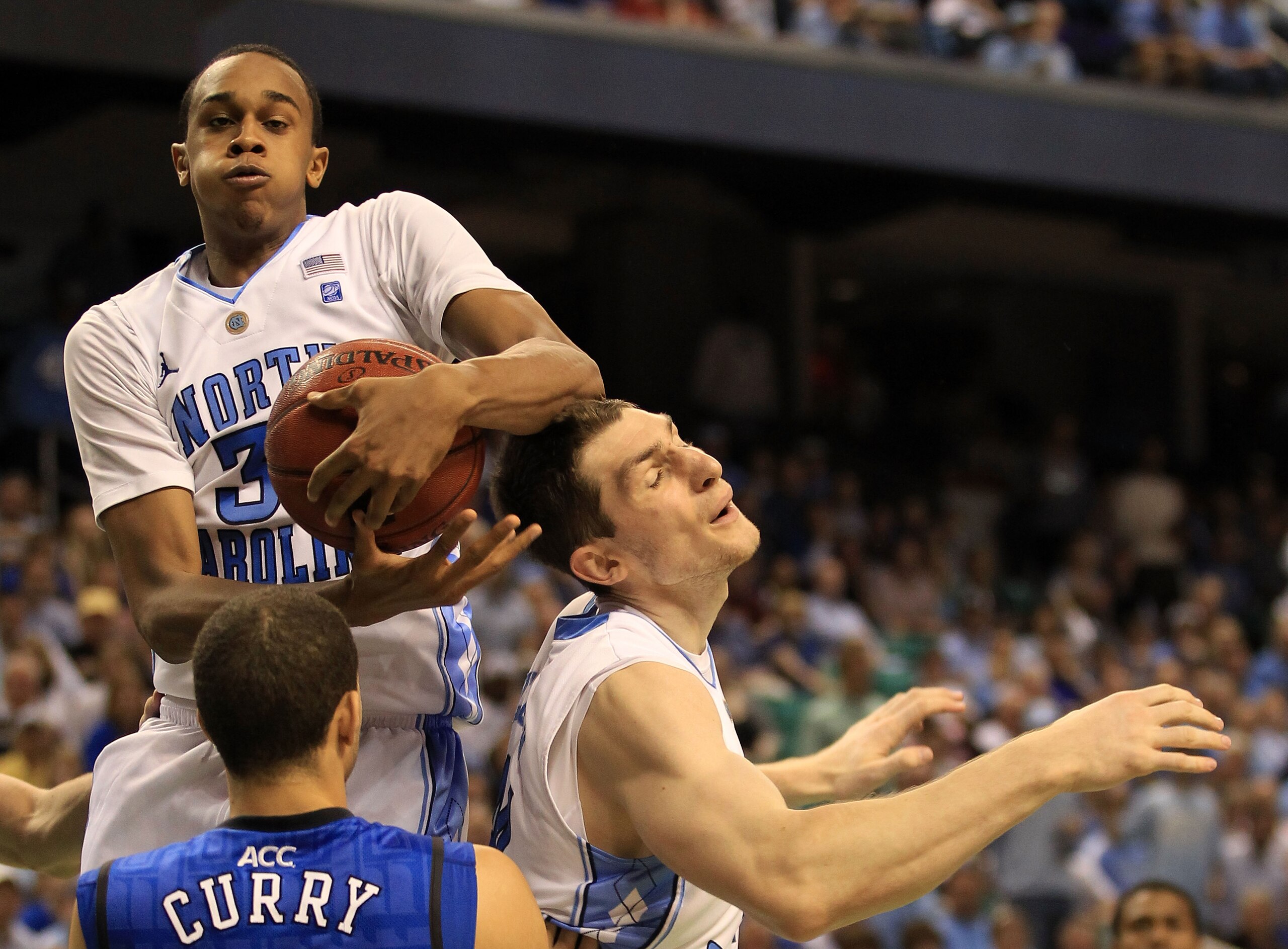 GREENSBORO, NC - MARCH 13: John Henson #31 of the North Carolina Tar Heels rebounds a shot by teammate Tyler Zeller #44 as Seth Curry #30 of the Duke Blue Devils looks on during the second half in the championship game of the 2011 ACC men's basketball to GREENSBORO, NC - MARCH 13: John Henson #31 of the North Carolina Tar Heels rebounds a shot by teammate Tyler Zeller #44 as Seth Curry #30 of the Duke Blue Devils looks on during the second half in the championship game of the 2011 ACC men's basketball to