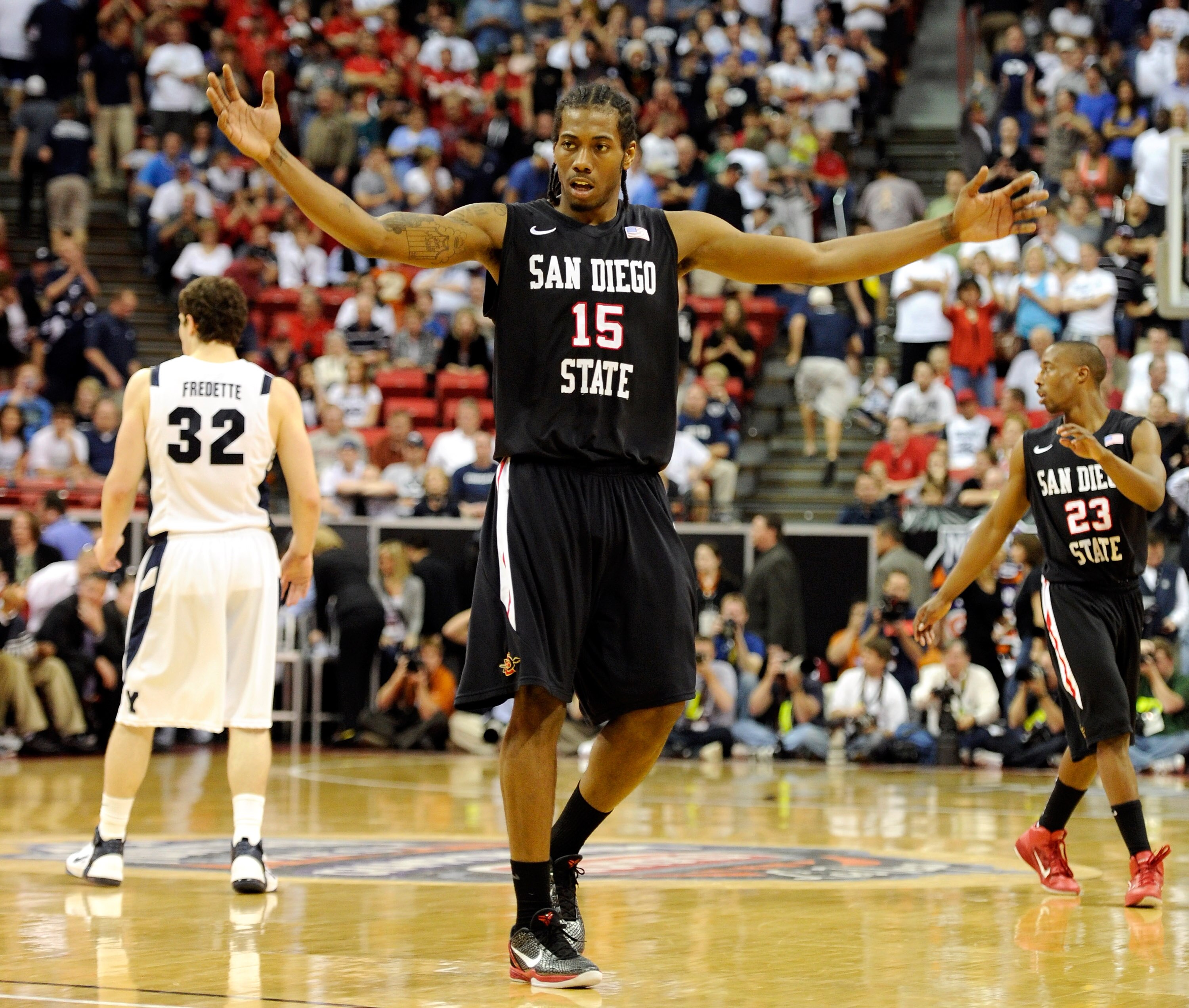 LAS VEGAS, NV - MARCH 12:  Kawhi Leonard #15 of the San Diego State Aztecs raises his arms in the last few seconds of the team's 72-54 victory over the Brigham Young University Cougars in the championship game of the Conoco Mountain West Conference Basket