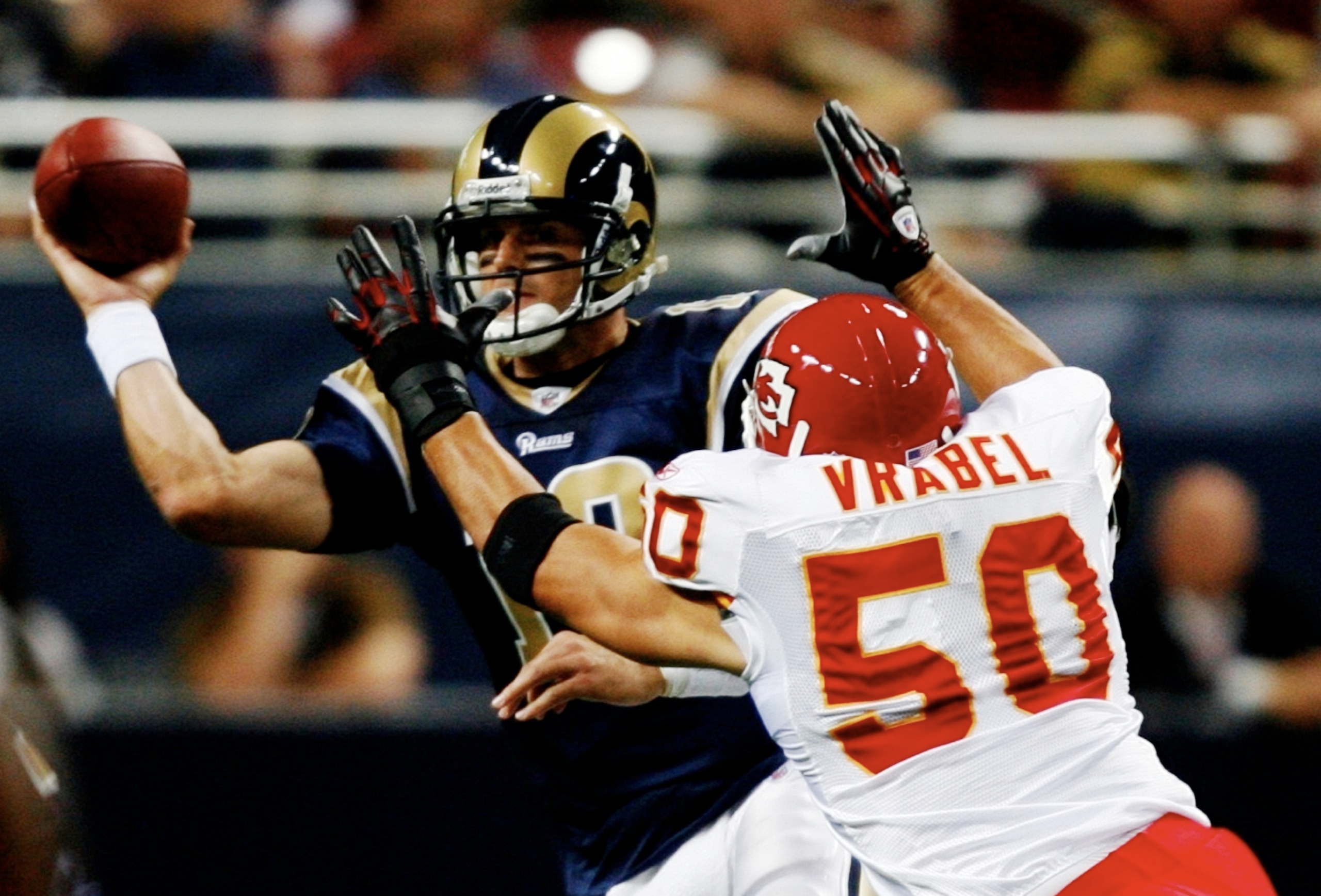 ST. LOUIS, MO - SEPTEMBER 03: Quarterback Kyle Boller #12 of the St. Louis Rams looks to pass over the defense of linebacker Mike Vrabel #50 of the Kansas City Chiefs during the first quarter of the preseason game at the Edward Jones Dome on September 3,