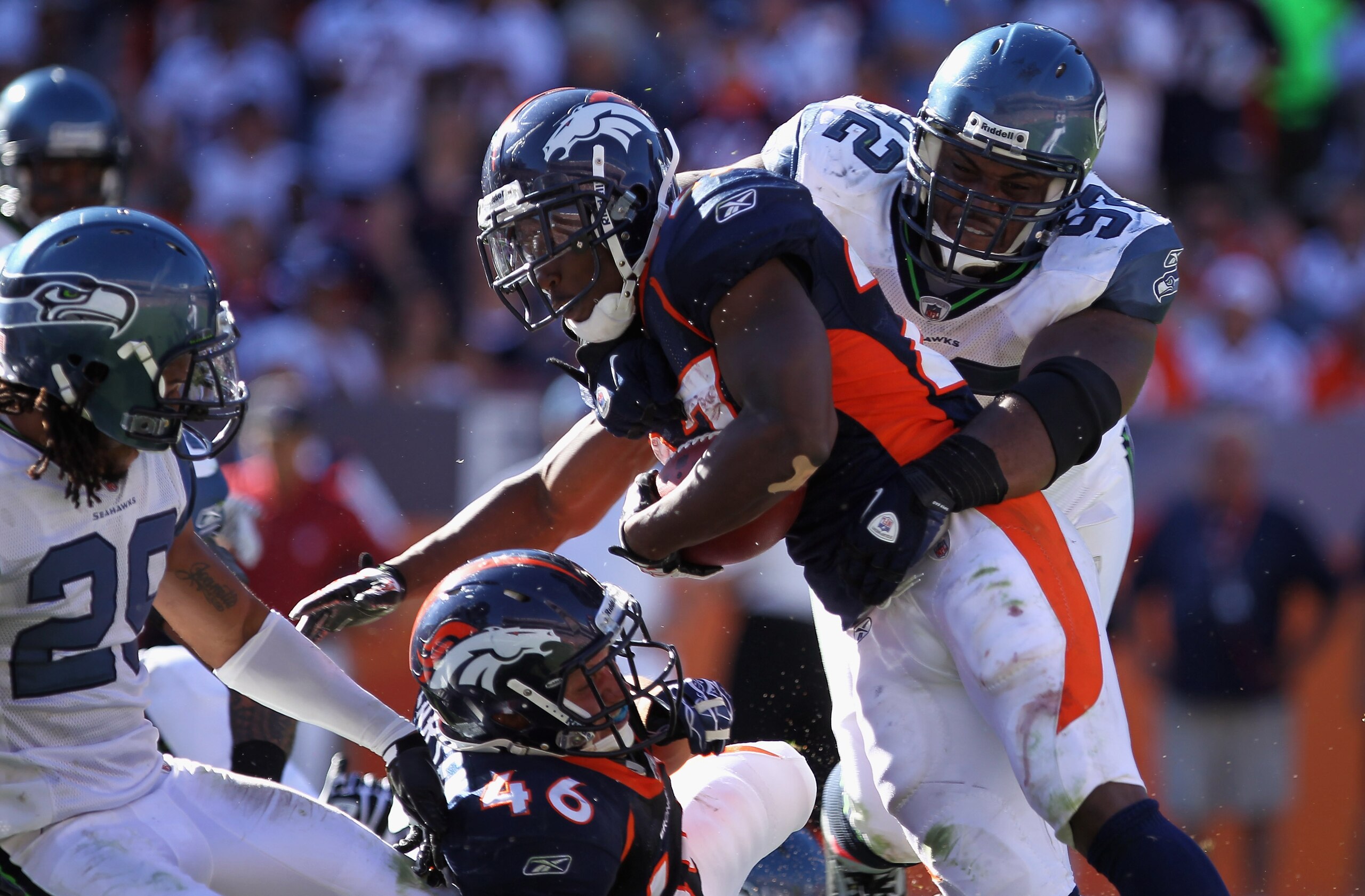 DENVER - SEPTEMBER 19:  Running back Knowshon Moreno #27 of the Denver Broncos is stopped by defensive tackle Brandon Mebane #92 of the Seattle Seahawks at INVESCO Field at Mile High on September 19, 2010 in Denver, Colorado. The Broncos defeated the Seah