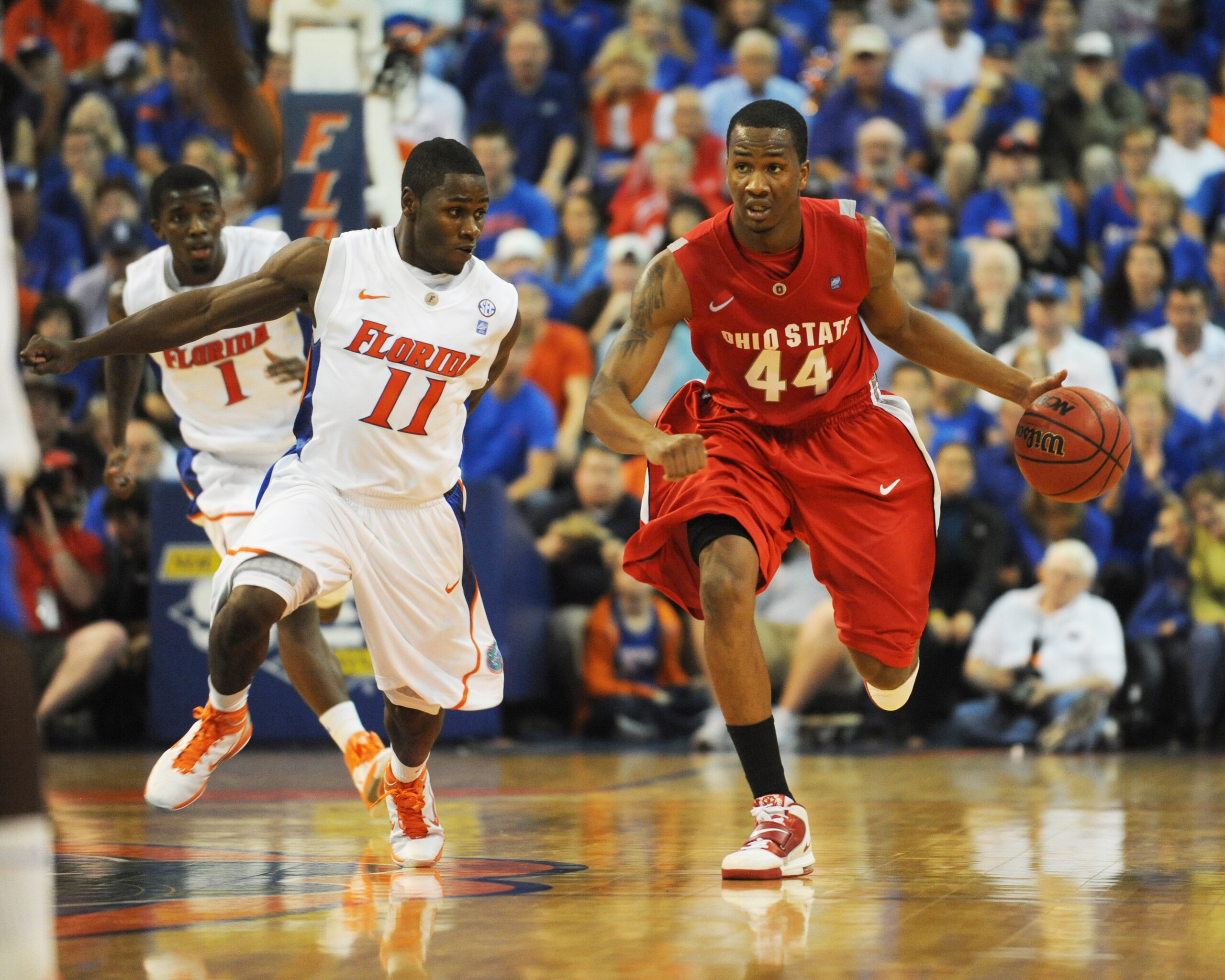 GAINESVILLE, FL - NOVEMBER 16: Guard William Buford #44 of the Ohio State Buckeyes drives up court against gurad Erving Walker #11  the Florida Gators November 16, 2010 at the Stephen C. O'Connell Center in Gainesville, Florida.  (Photo by Al Messerschmid