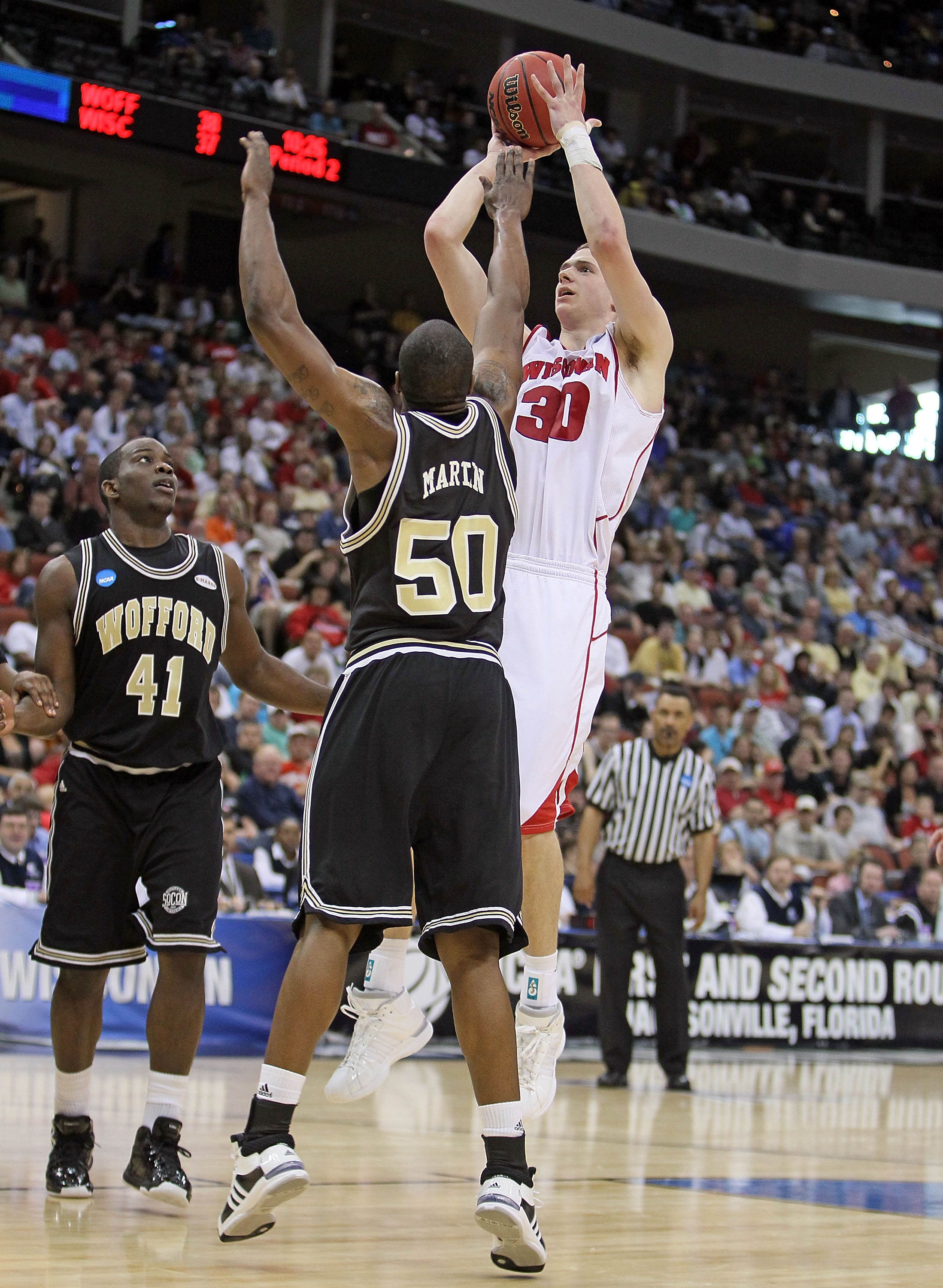 JACKSONVILLE, FL - MARCH 19:  Jon Leuer #30 of the Wisconsin Badgers shoots the ball while defended by Terry Martin #50 of the Wofford Terriers during the first round of the 2010 NCAA men's basketball tournament at Jacksonville Veteran's Memorial Arena on