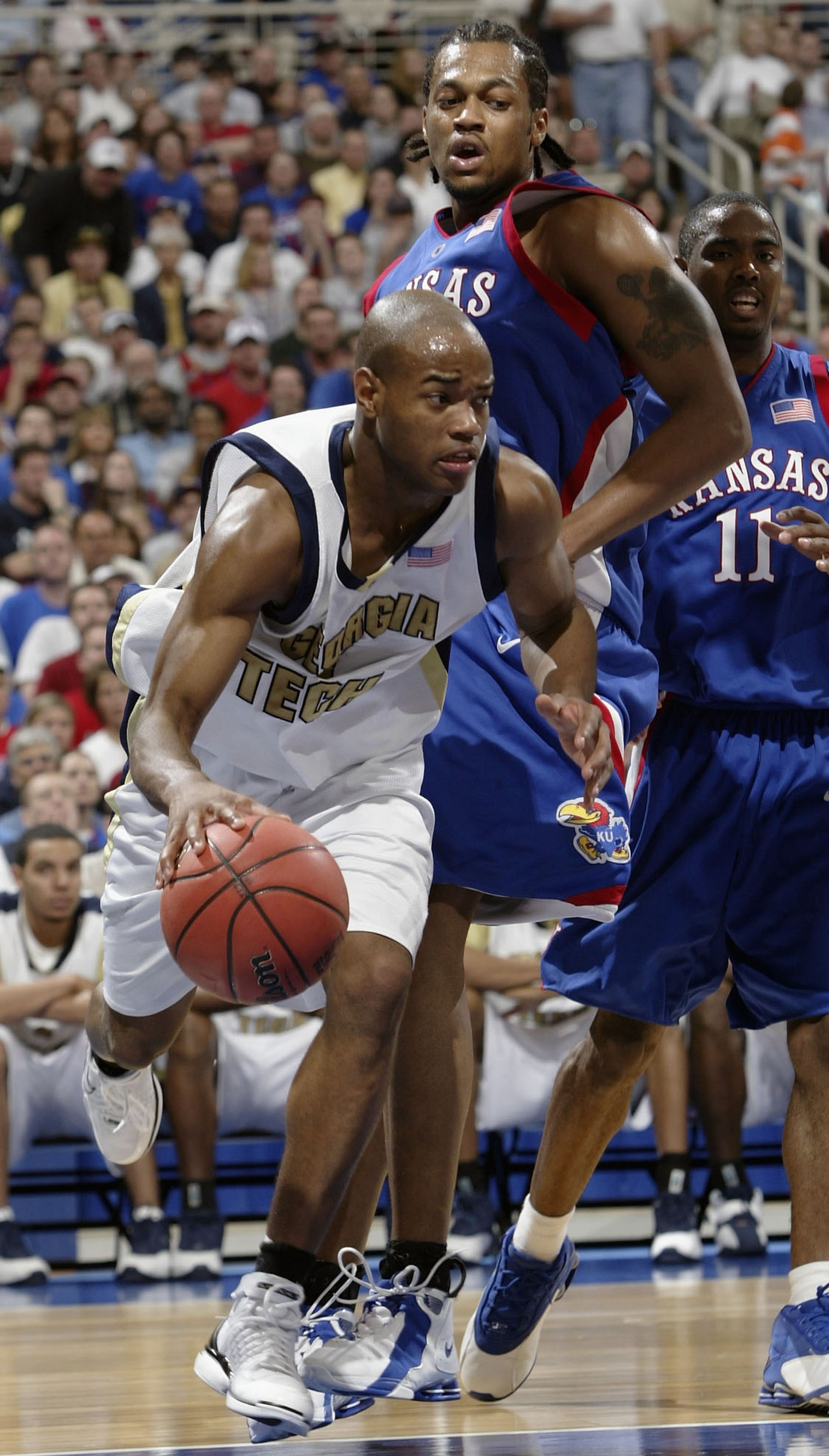 ST. LOUIS - MARCH 28: Jarrett Jack #3 of the Georgia Tech Yellow Jackets drives past Jeff Graves #42 of the Kansas Jayhawks during the fourth round game of the NCAA Division I Men's Basketball Tournament at the Edward Jones Dome on March 28, 2004 in St. L ST. LOUIS - MARCH 28: Jarrett Jack #3 of the Georgia Tech Yellow Jackets drives past Jeff Graves #42 of the Kansas Jayhawks during the fourth round game of the NCAA Division I Men's Basketball Tournament at the Edward Jones Dome on March 28, 2004 in St. L