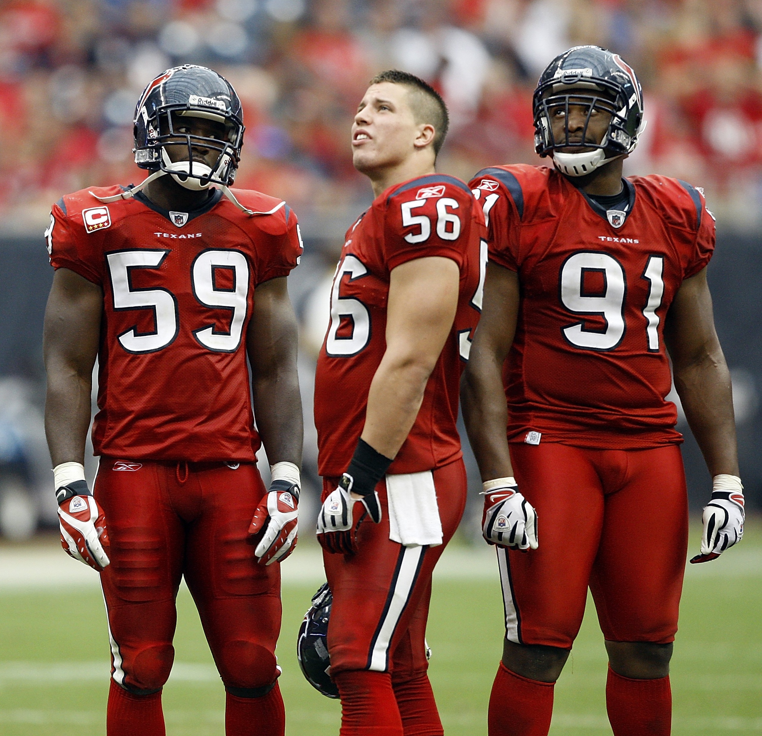 HOUSTON - SEPTEMBER 27:  Linebackers DeMeco Ryans #59, Brian Cushing #56 and defensive tackle  Amobi Okoye #91 of the Houston Texans watch the instant replay of the goal-line fumble during a breakin the game against the Jacksonville Jaguars at Reliant Sta